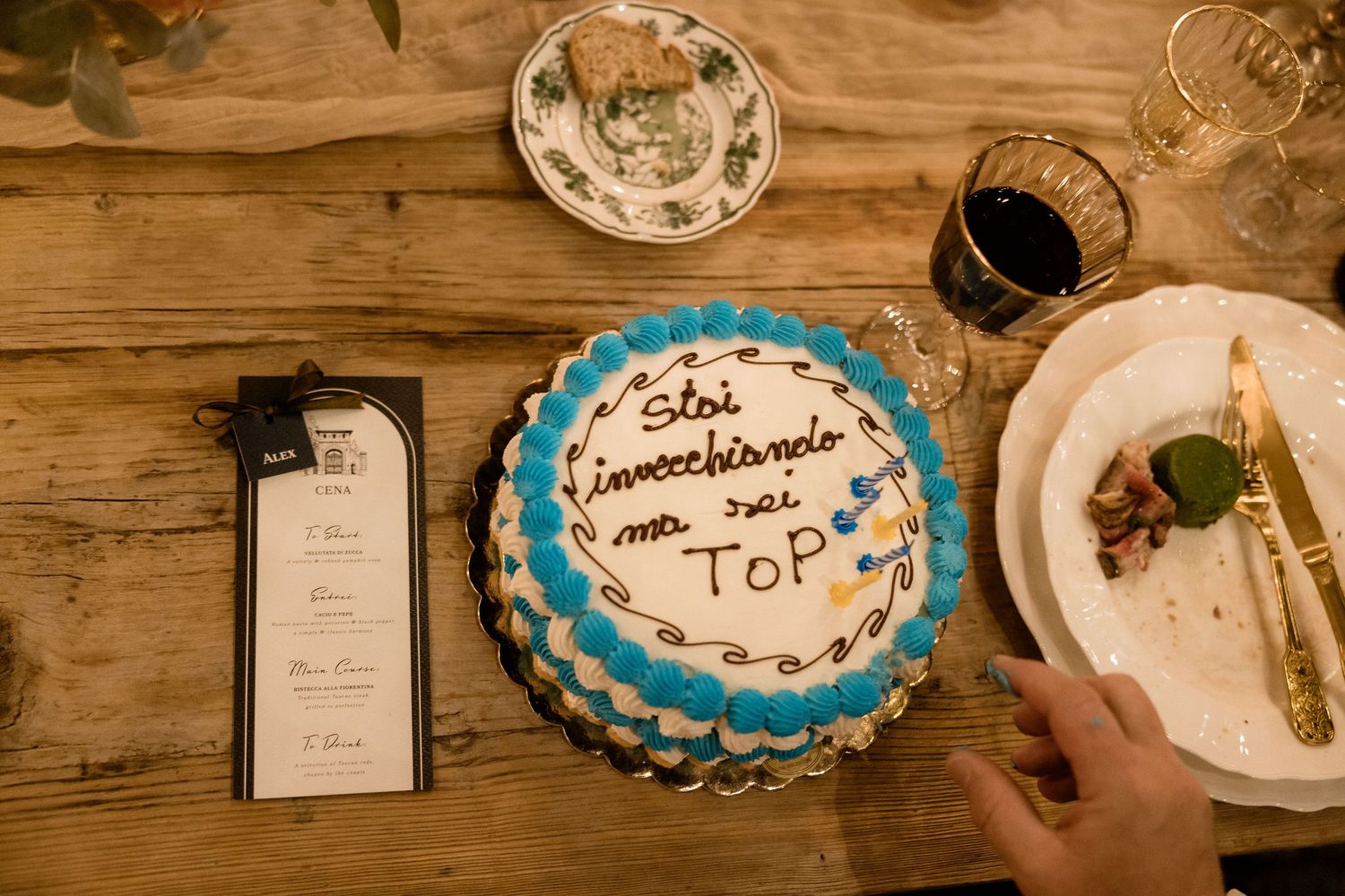 A collection of dessert plates and decorative items arranged on a rustic wooden table surface.
