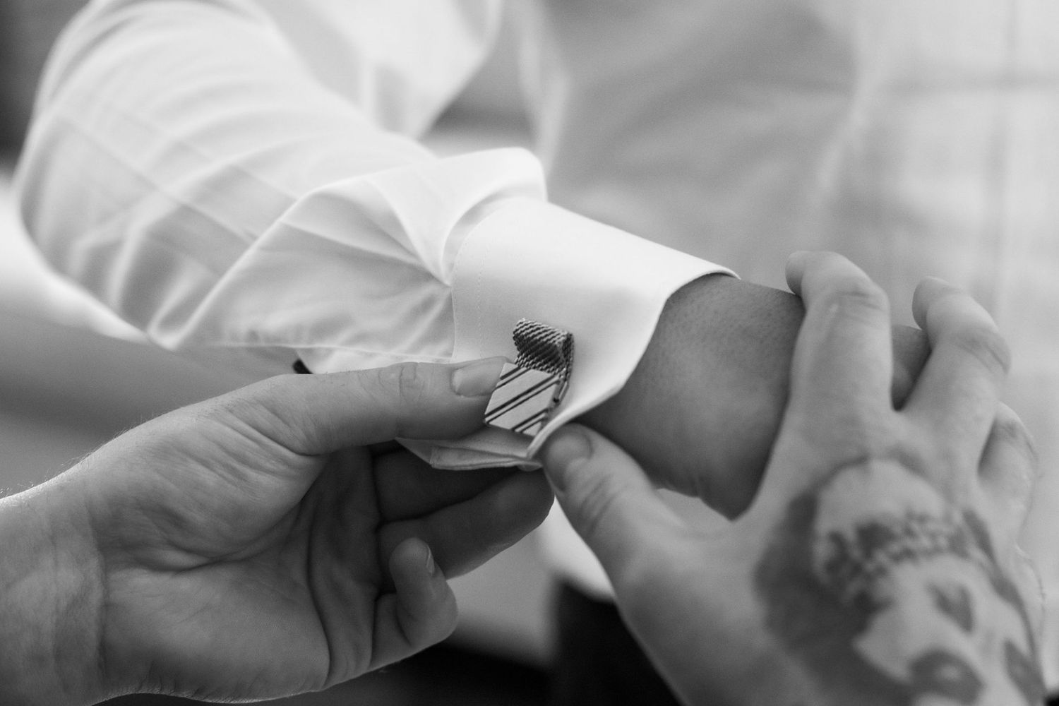 A series of black and white photos showing hands gently touching and caressing in an intimate sequence.