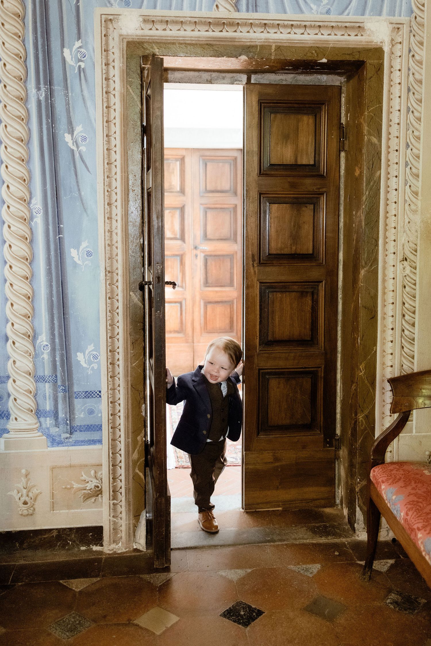A sequence of images showing someone peering through a doorway in an ornate historic interior with wooden doors.