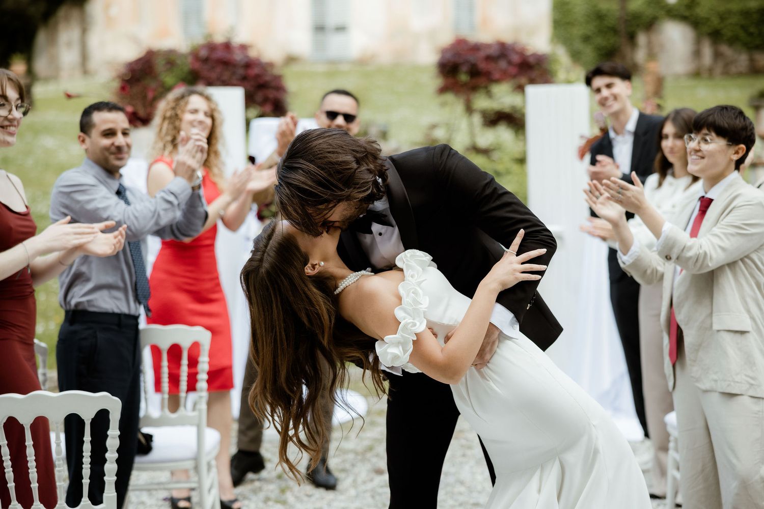 Wedding celebration filled with lively dancing and guests in formal attire enjoying the festivities at an outdoor venue.