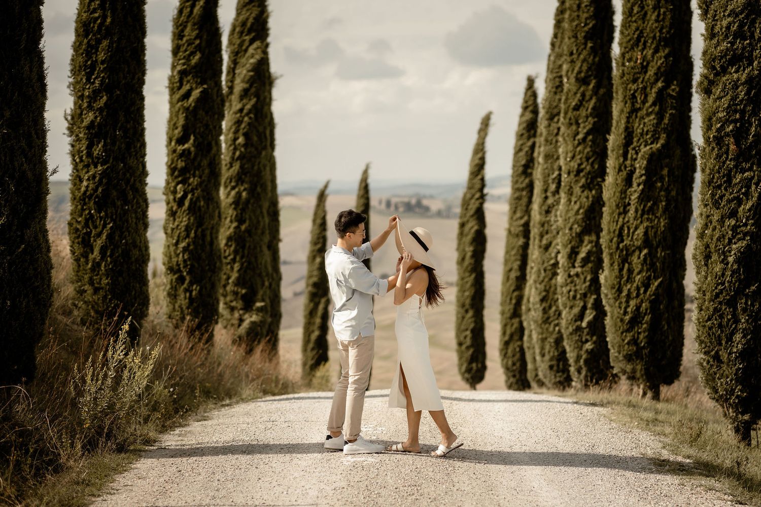 Joyful moment captured on a cypress-lined road in Tuscany.