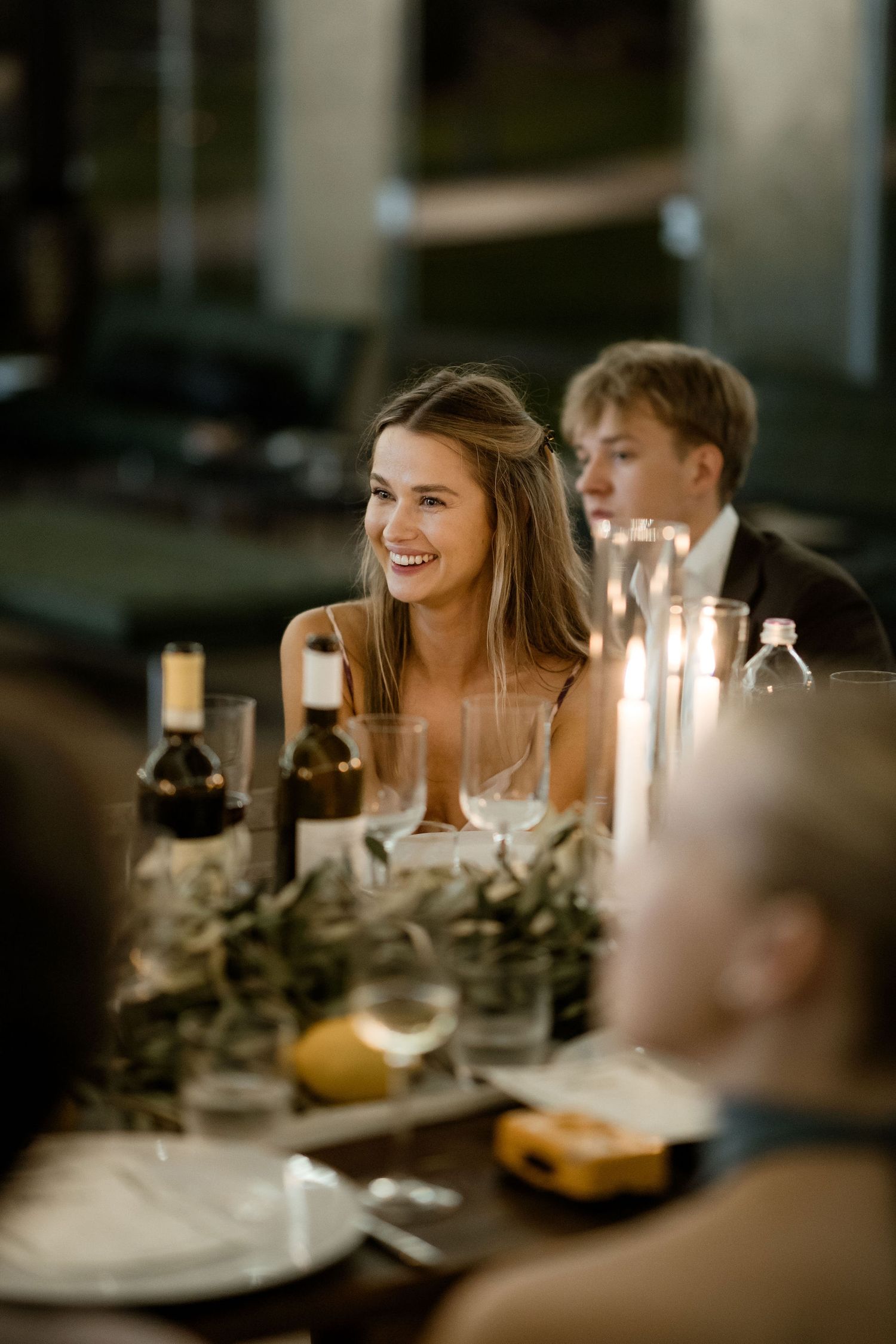 Candlelit dinner table setting with wine glasses and decorative elements creating an intimate atmosphere.