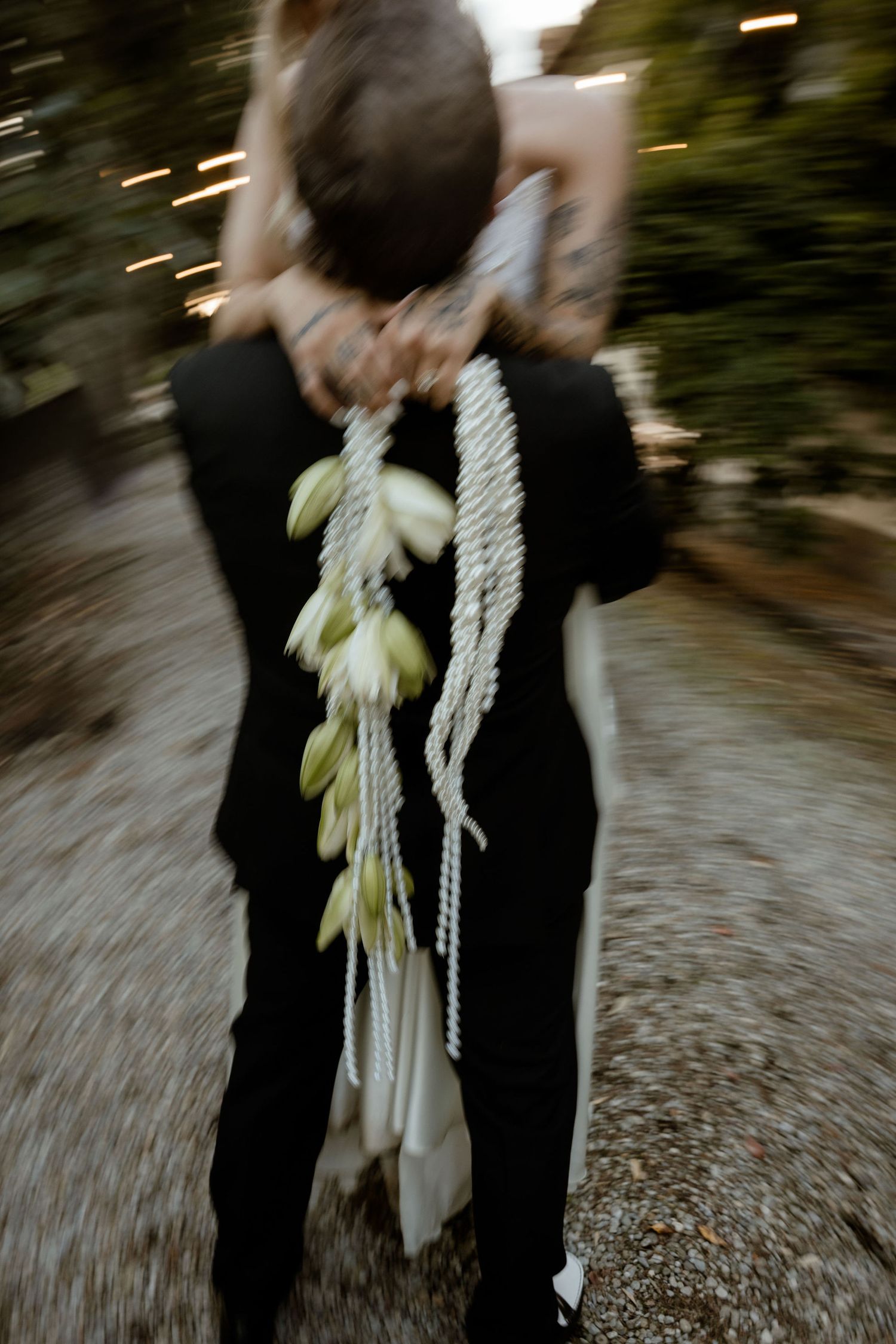 A blurred motion sequence shows a couple in formal attire with white rope accessories walking outdoors.
