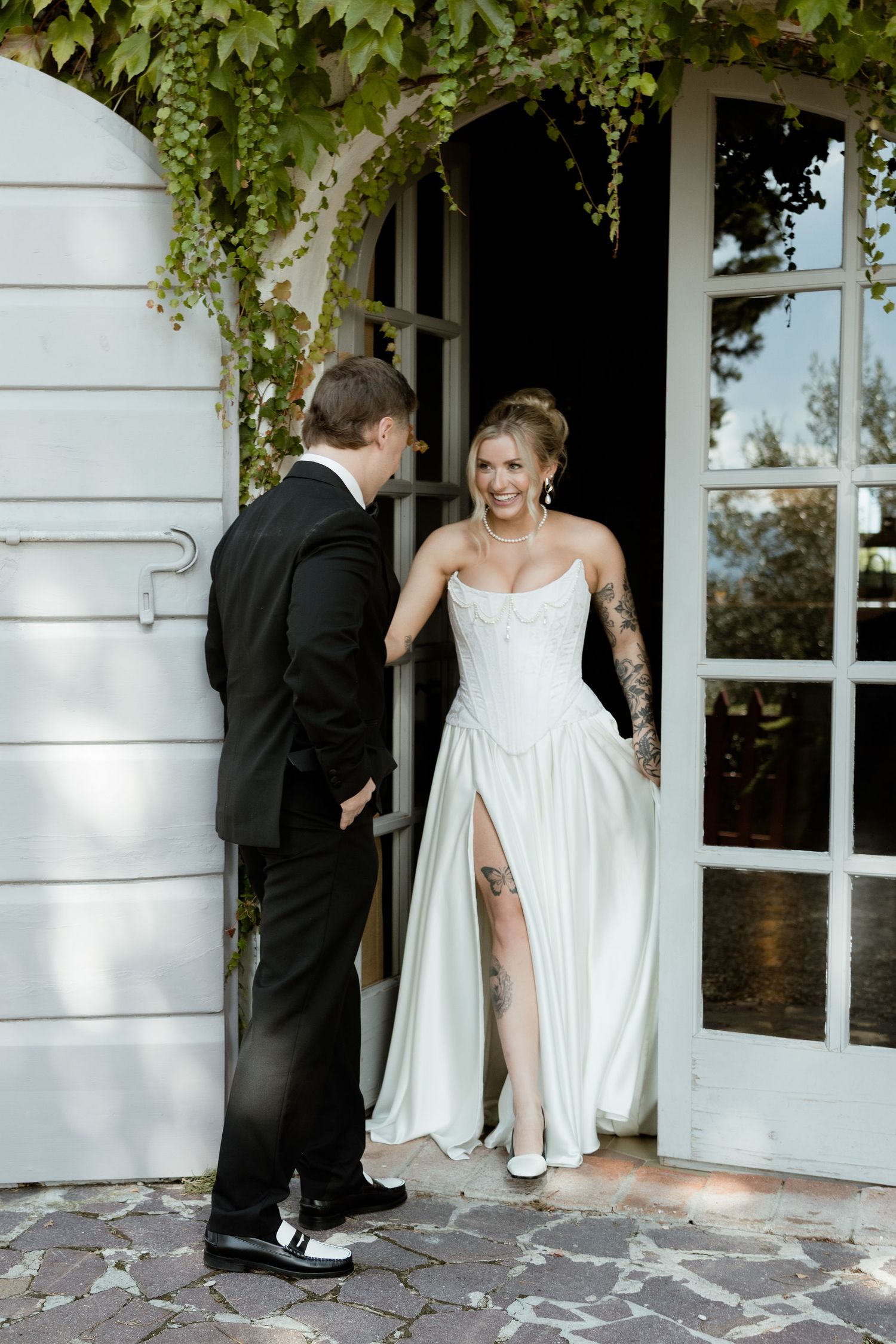 A sequence of photos showing a bride and groom playfully peeking around white columns at their wedding venue.