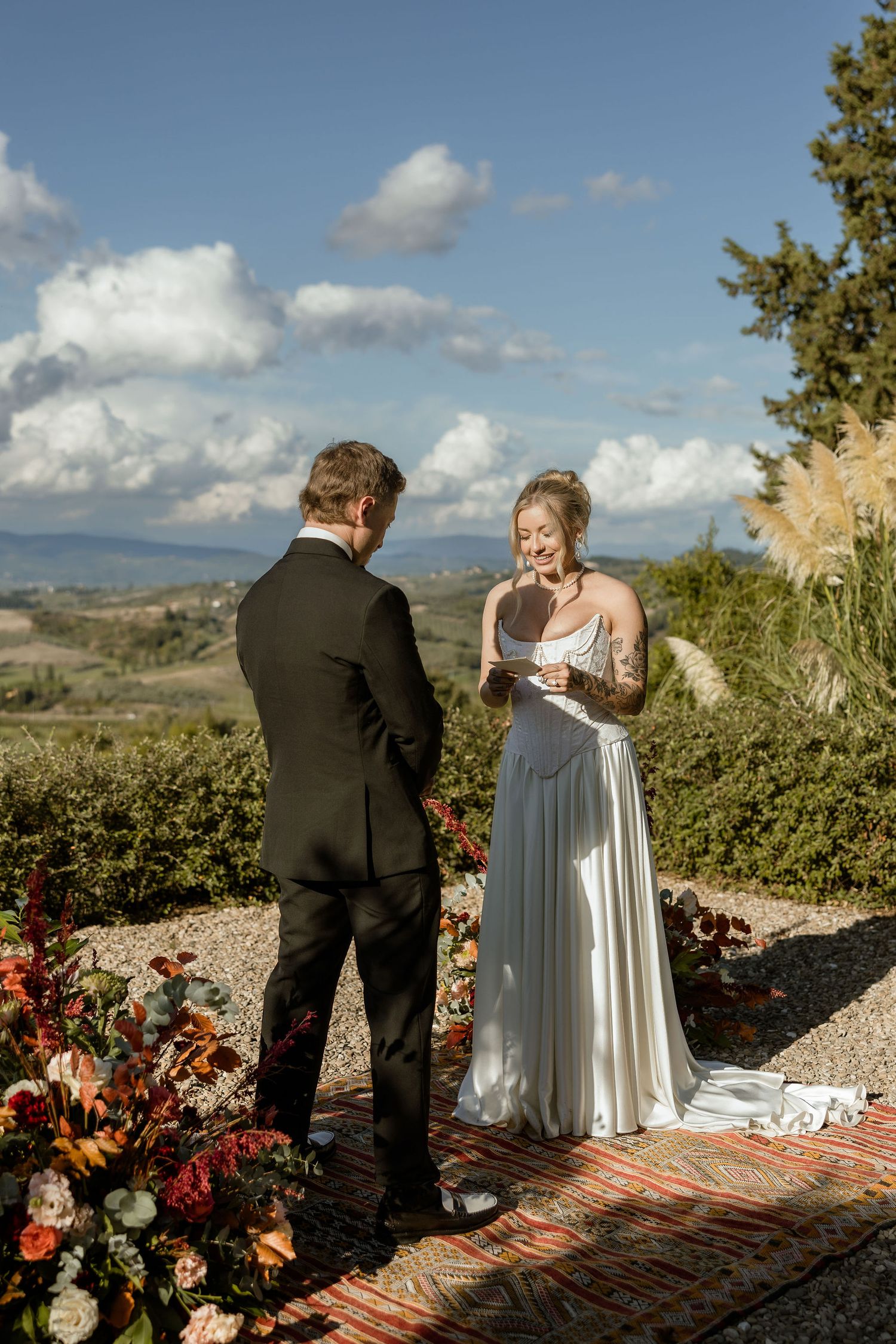 Outdoor wedding ceremony sequence showing couple exchanging rings on scenic mountain overlook with dramatic landscape views.