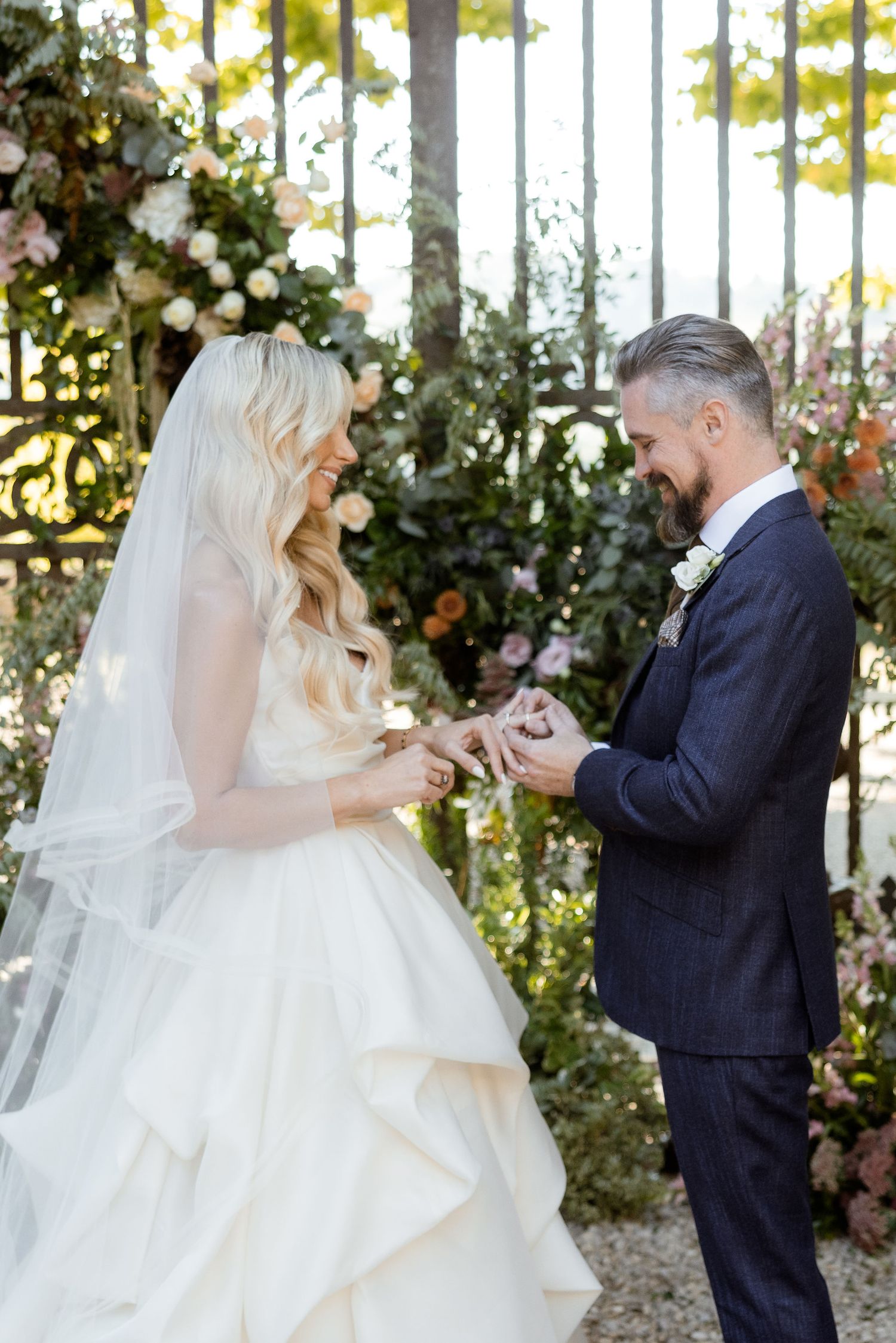 A couple shares an emotional first look moment during their outdoor garden wedding ceremony.