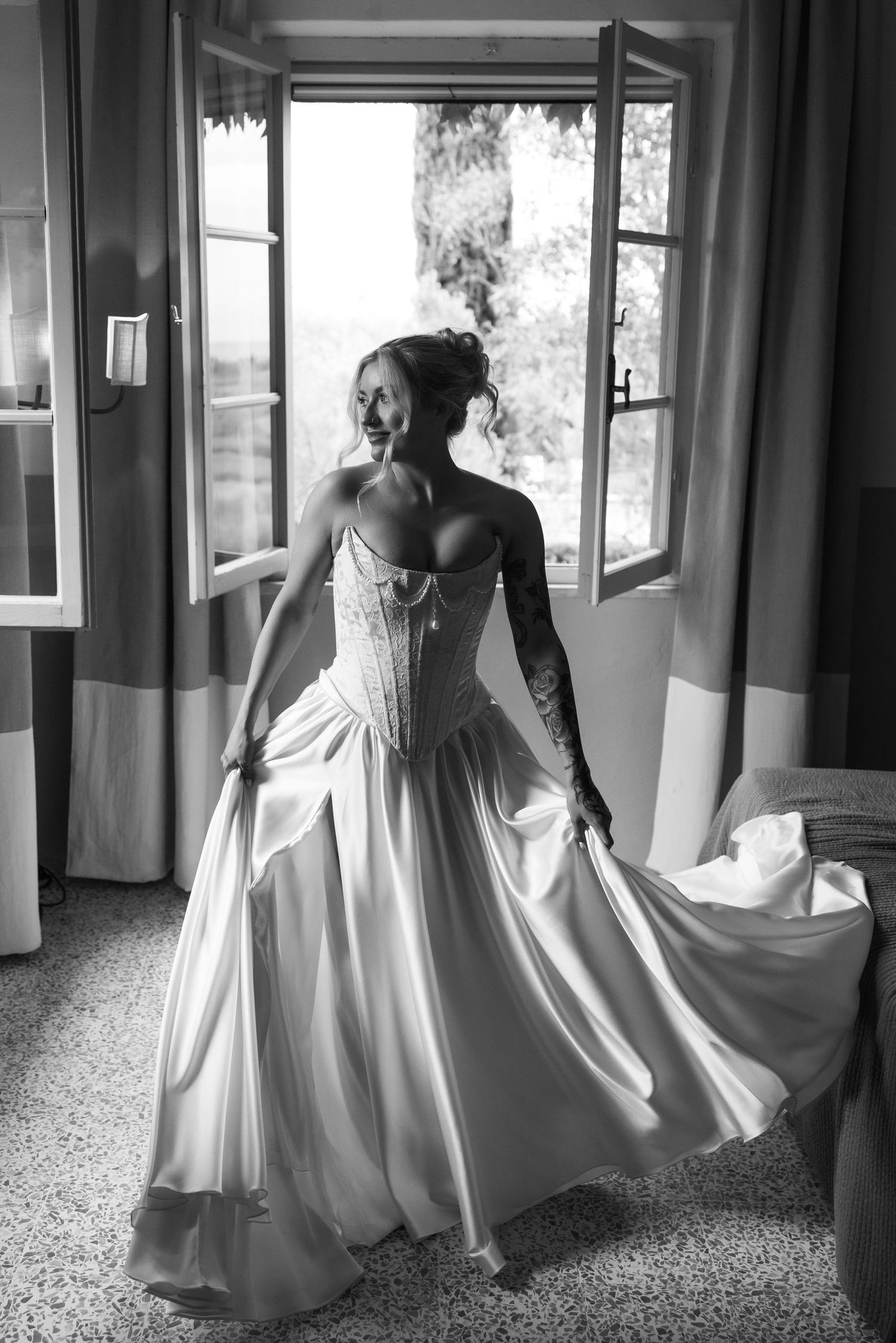 A series of black and white photos showing a person in a flowing white dress moving gracefully through a hallway.