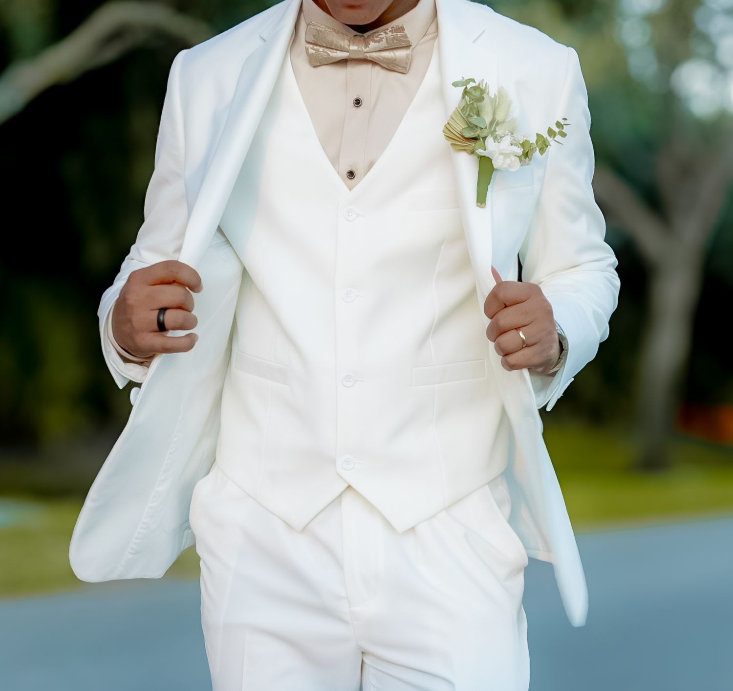 Detailed shot of a crisp white tuxedo with boutonniere.