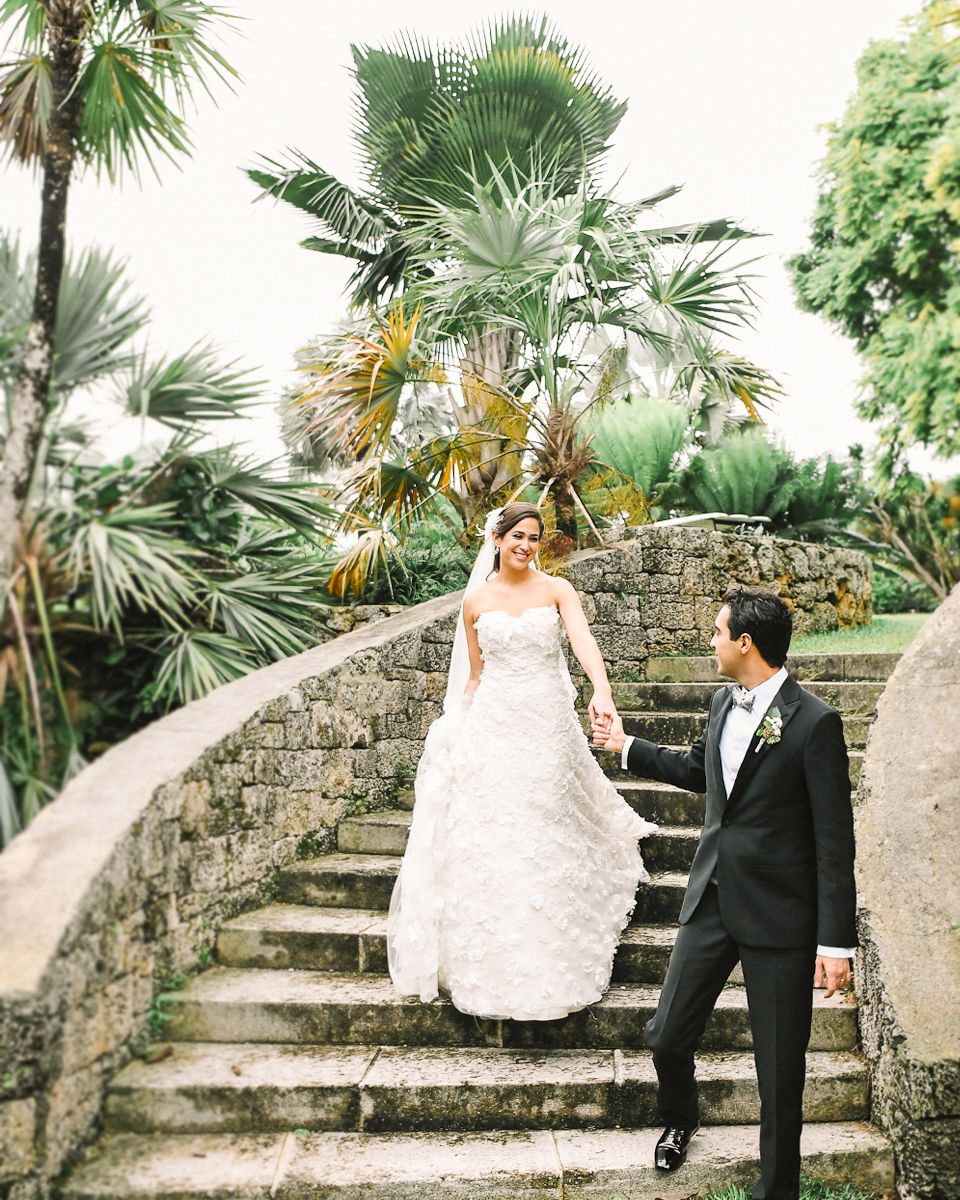 Stone staircase surrounded by lush tropical palm trees and gardens.