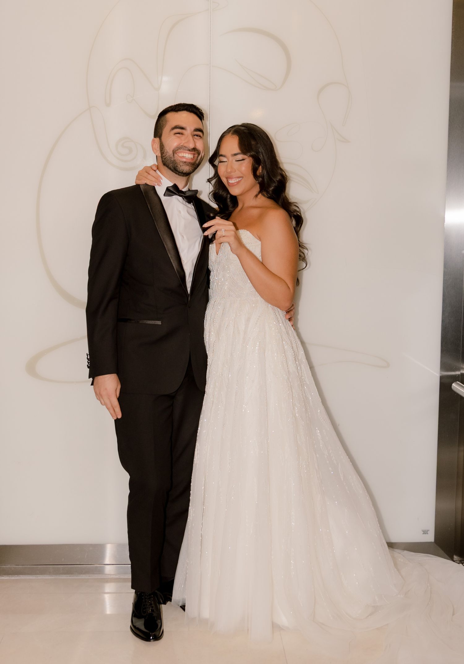 A series of joyful candid moments captured against a white wall at a wedding celebration.