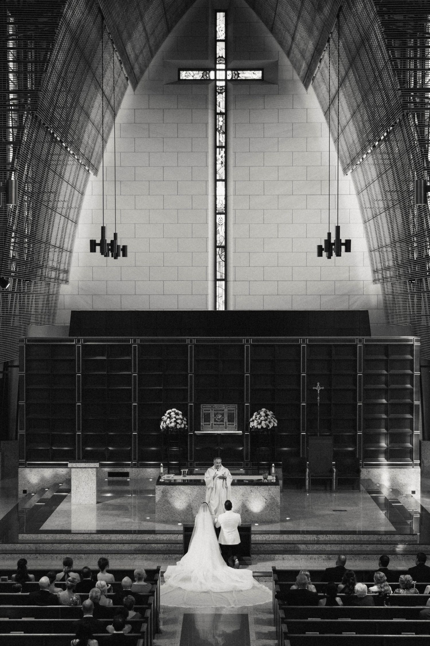 A black and white photo series showing the interior of a church sanctuary with pews, altar, and cross during a wedding ceremony.