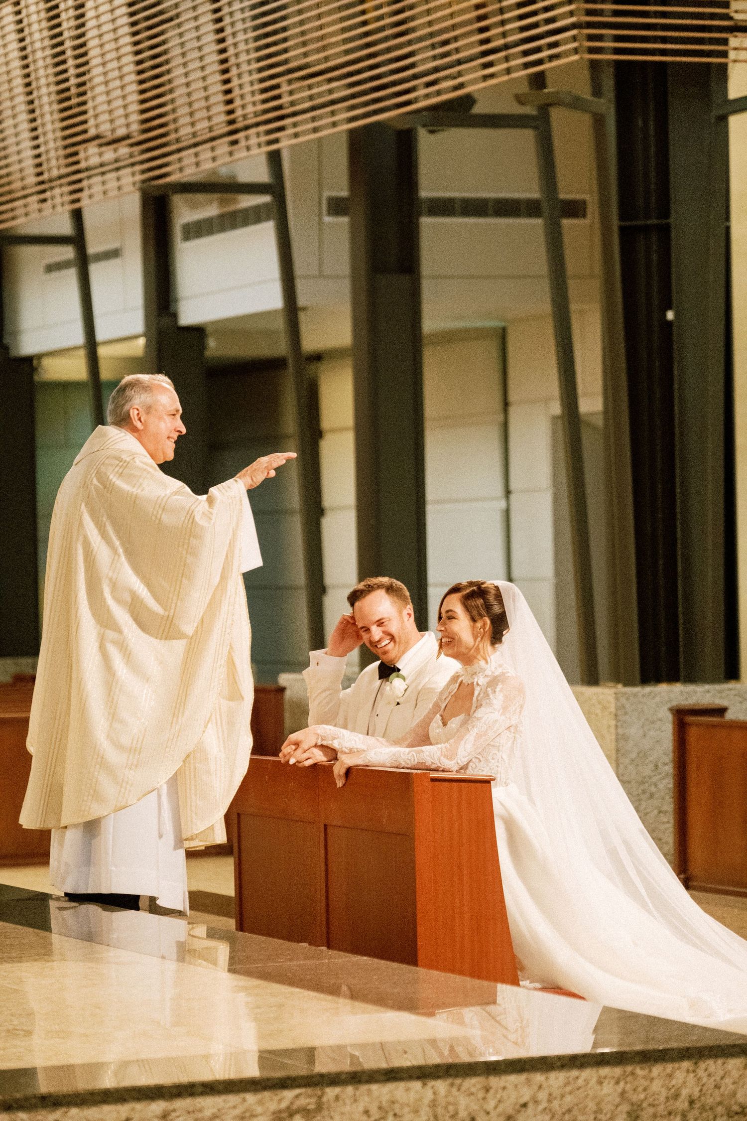 Three connected photos show figures in flowing white robes moving gracefully across a minimalist architectural space.