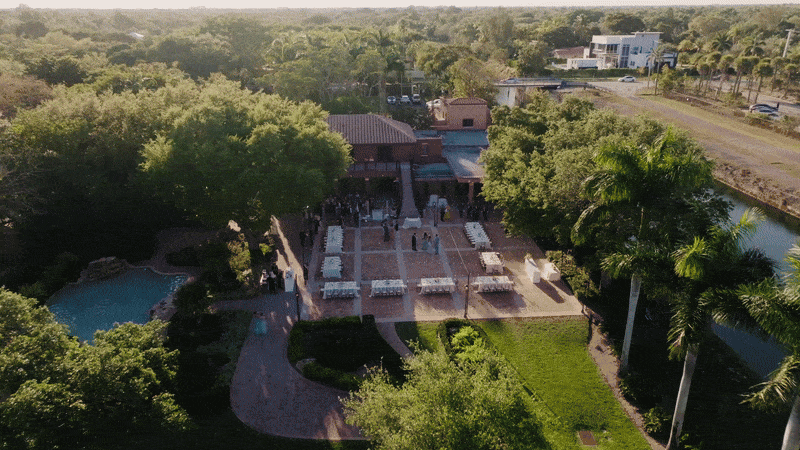Multiple aerial drone photos showcase a residential neighborhood with palm trees, buildings, and roads from different angles.