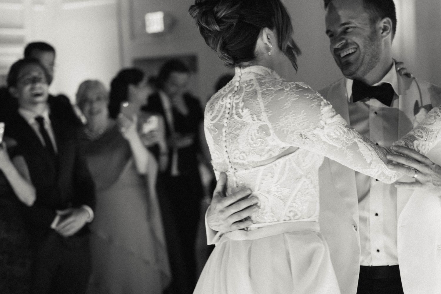 Black and white photo captures an intimate dance moment at an elegant wedding reception.