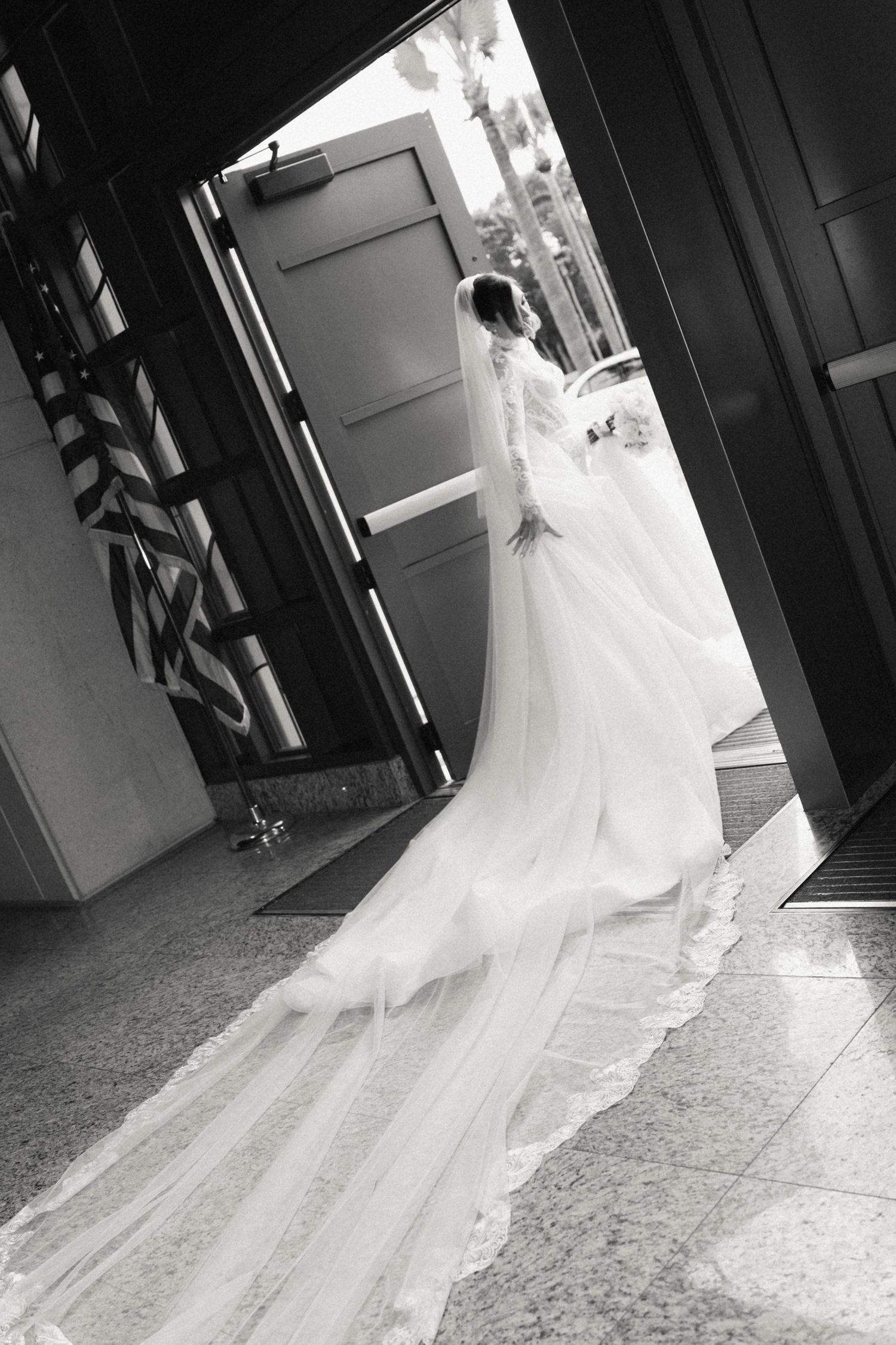 A sequence of black and white photos showing a wedding dress train flowing behind someone walking through a doorway.