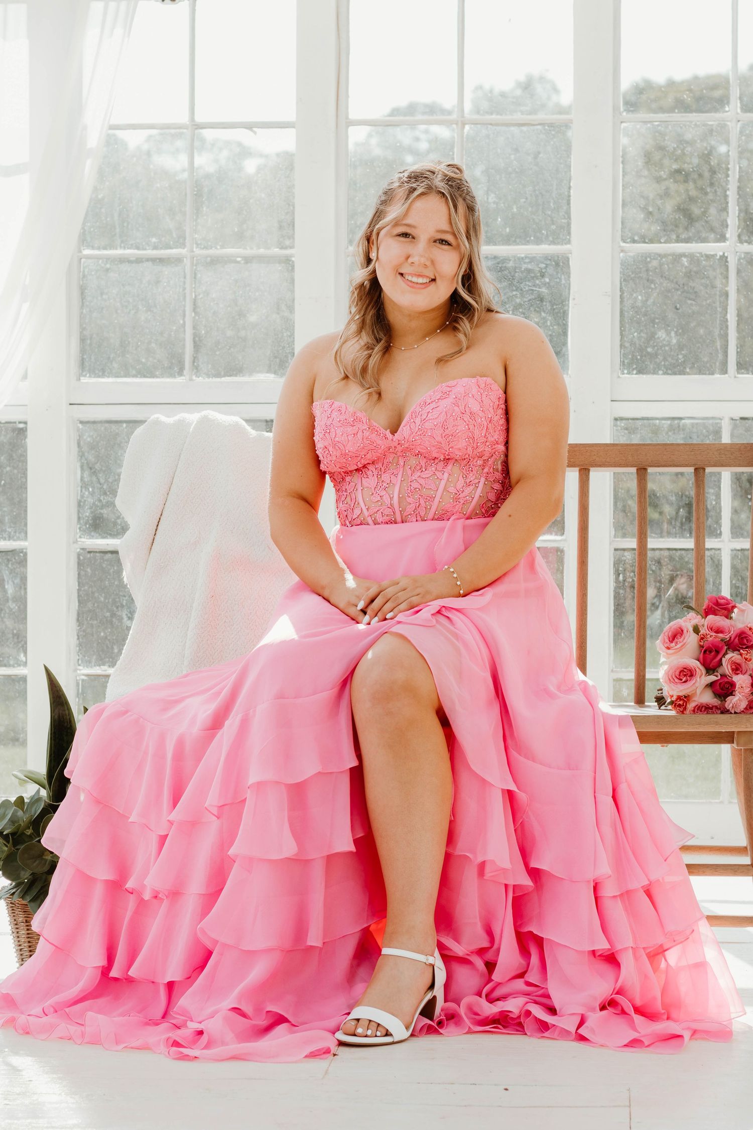 Pink ruffled ball gown with sweetheart neckline photographed in a bright white greenhouse setting in Clarkesville, GA.