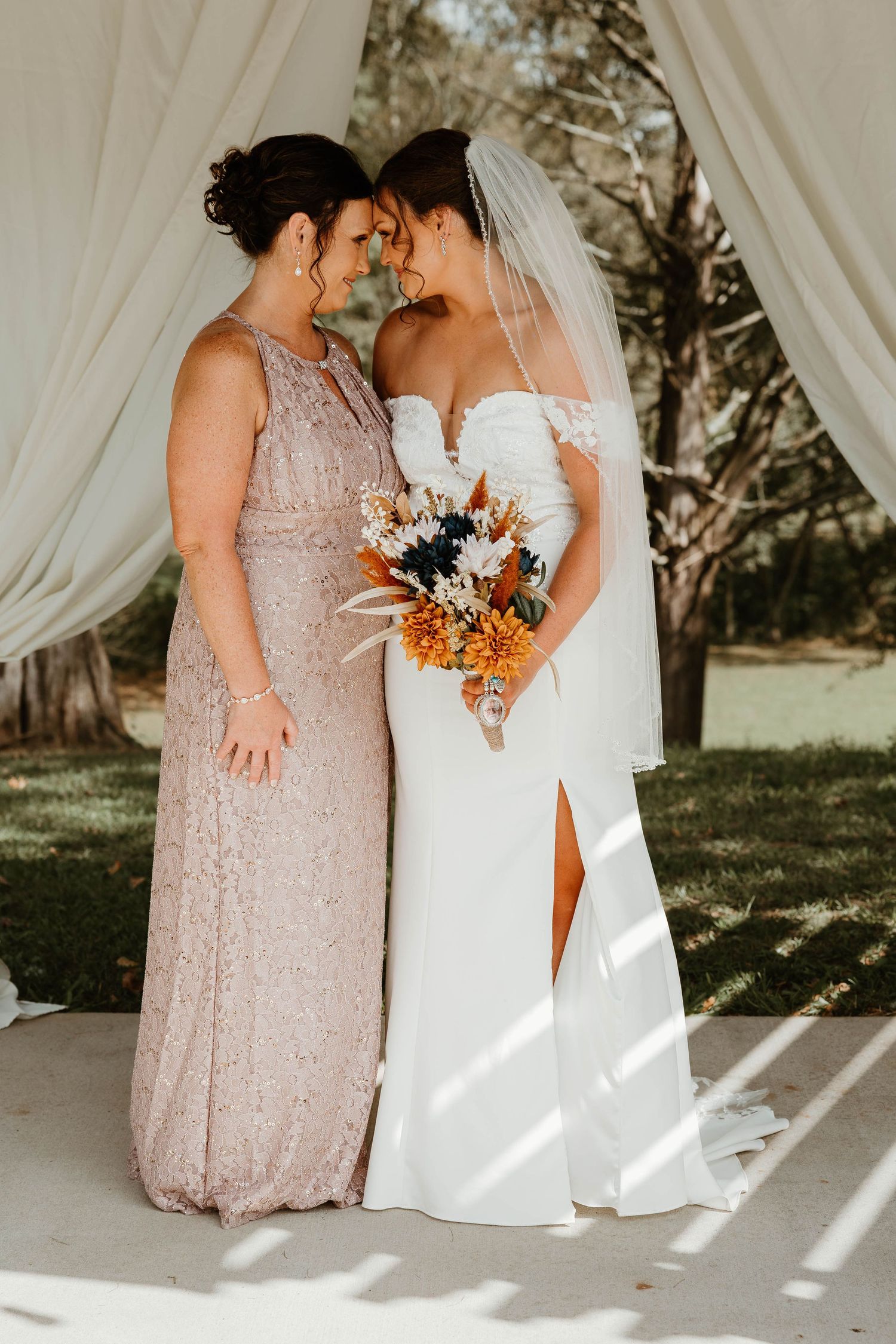 Elegant wedding scene with white flowing curtains showing close-up details of bridal gown and blush bridesmaid dress.