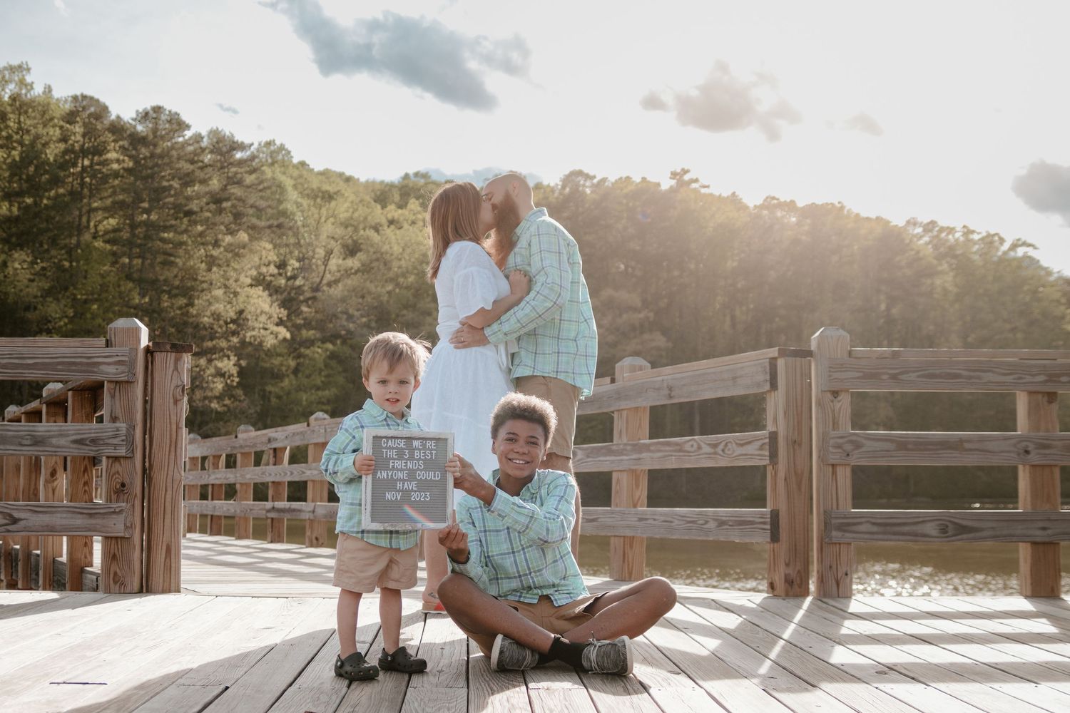 Golden sunset photo on a wooden deck with people in coordinating blue outfits in Toccoa, Georgia.