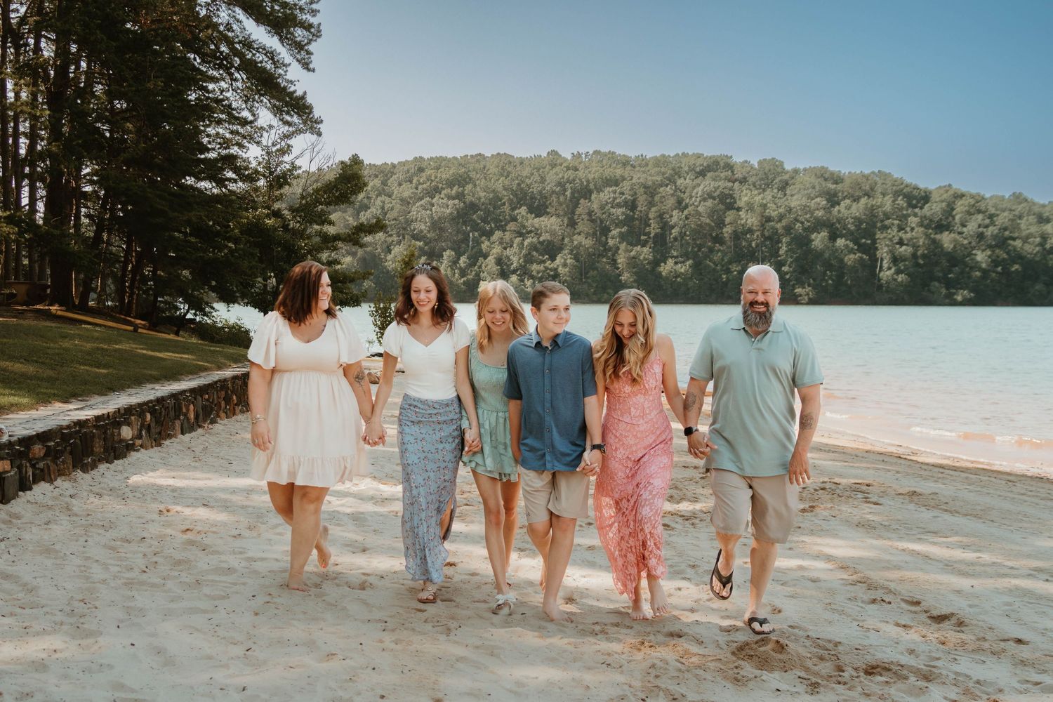 Group walking along a lakeside beach path during golden hour at Tugaloo State Park in northeast Georgia.