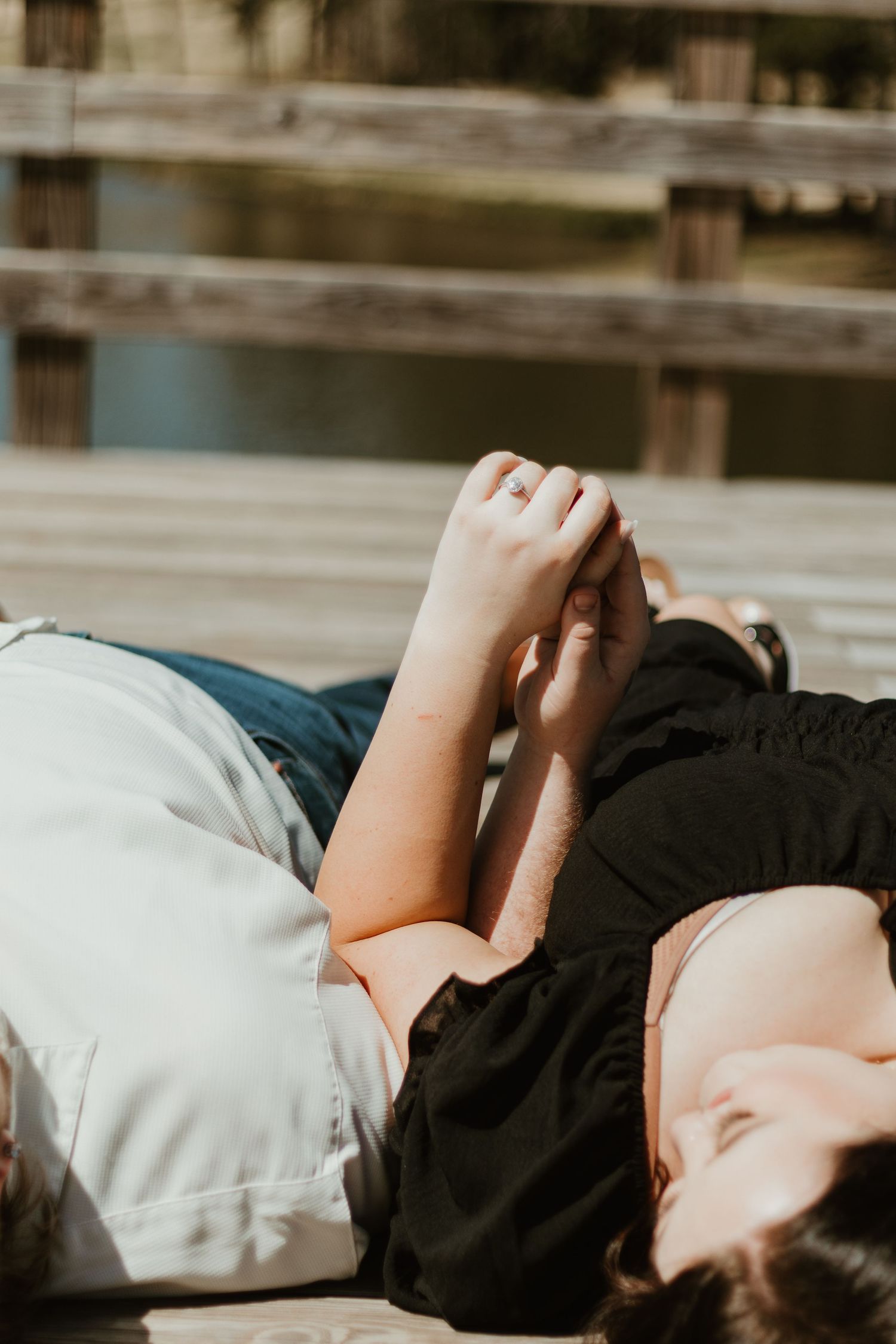 Person lying down and relaxing on a light colored surface in subdued lighting.
