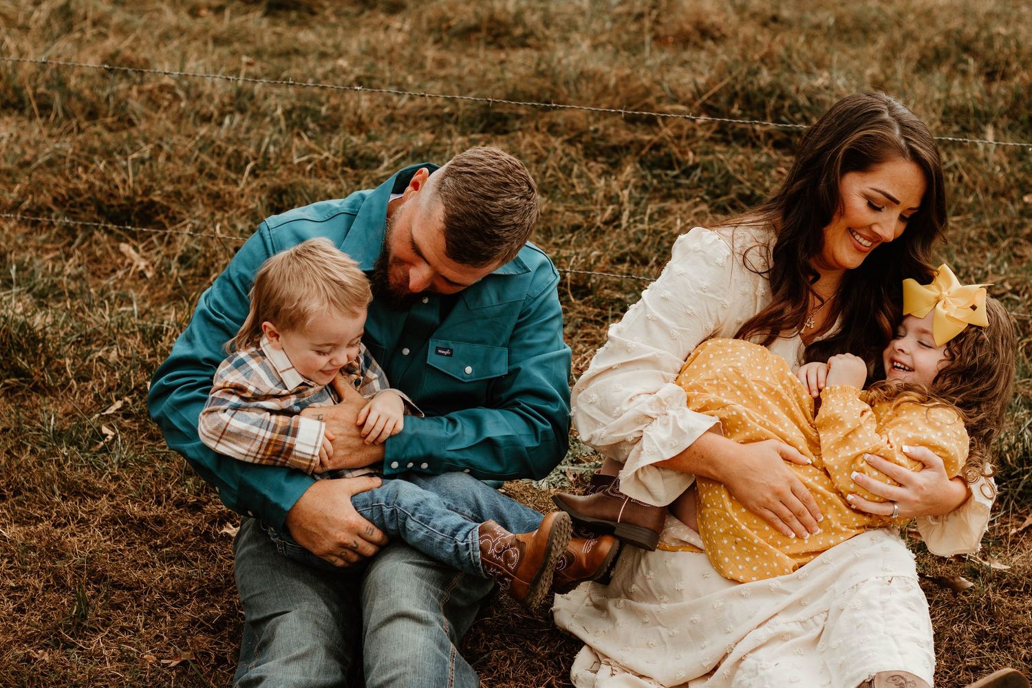 Family cuddles together playfully in a series of warm autumn outdoor portraits in golden light at a farm in Northeast Georgia.