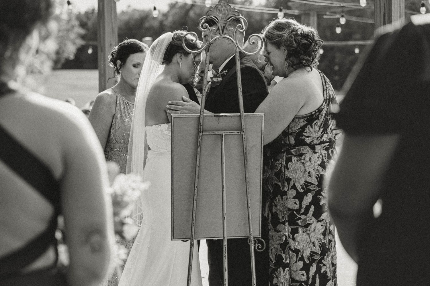 Wedding guests gathered around during an indoor reception celebration.