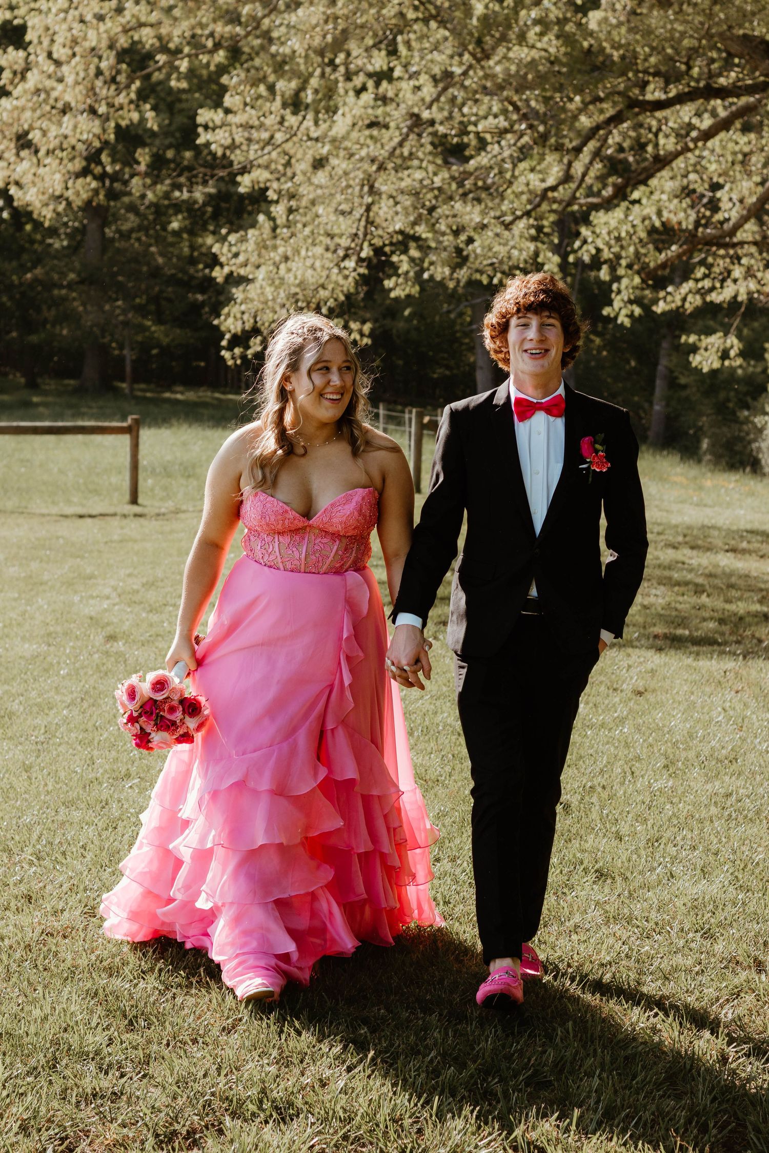 Outdoor formal portraits in spring with pink ruffled dress and black tuxedo in northeast Georgia.