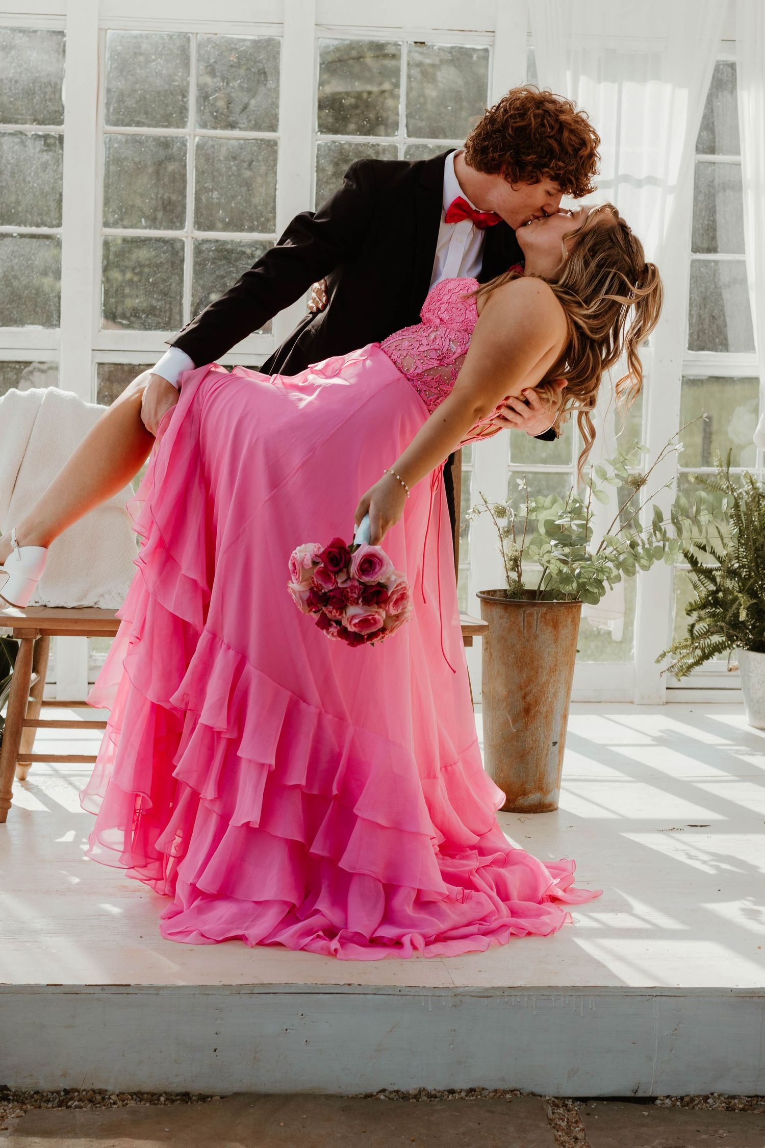 Sunlit formal portraits in a greenhouse with flowing pink gown in Clarkesville, GA.