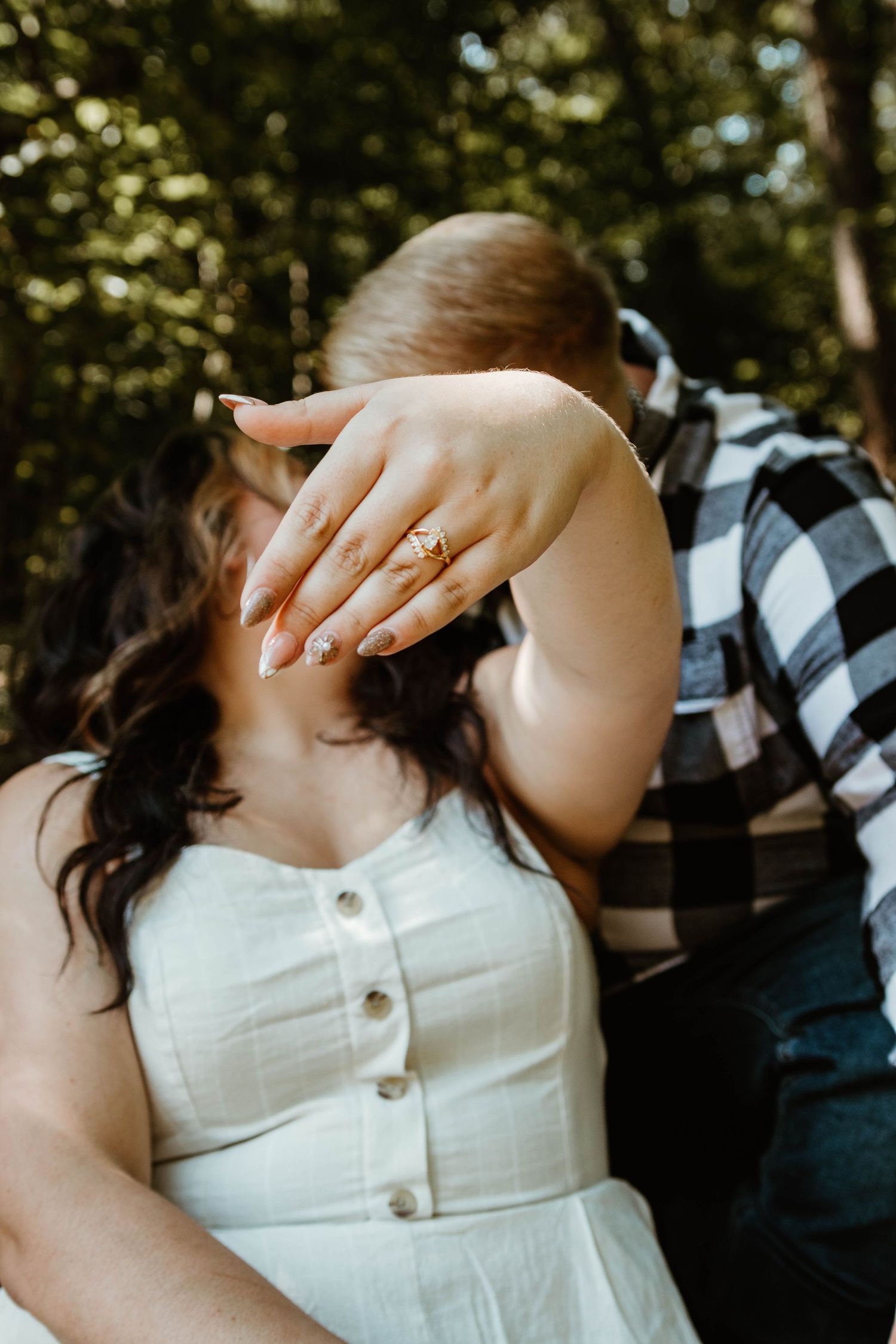 A close-up series showing a white engagement ring on a hand against a dark background with plaid fabric details.