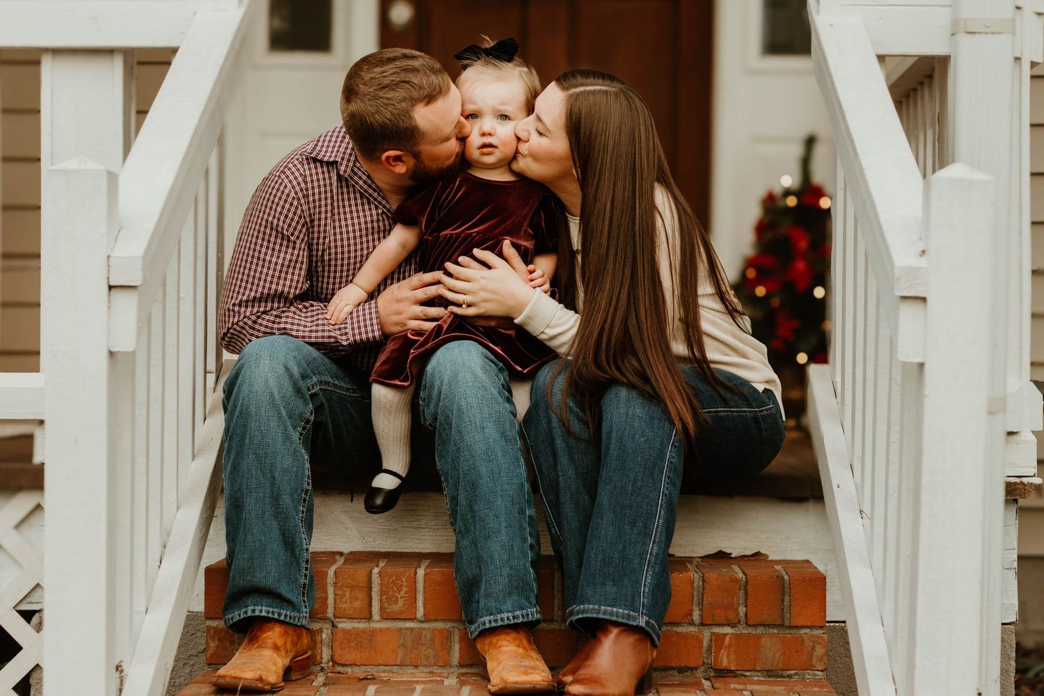 Intimate family moments captured on white porch stairs during holiday season in Commerce, Georgia.