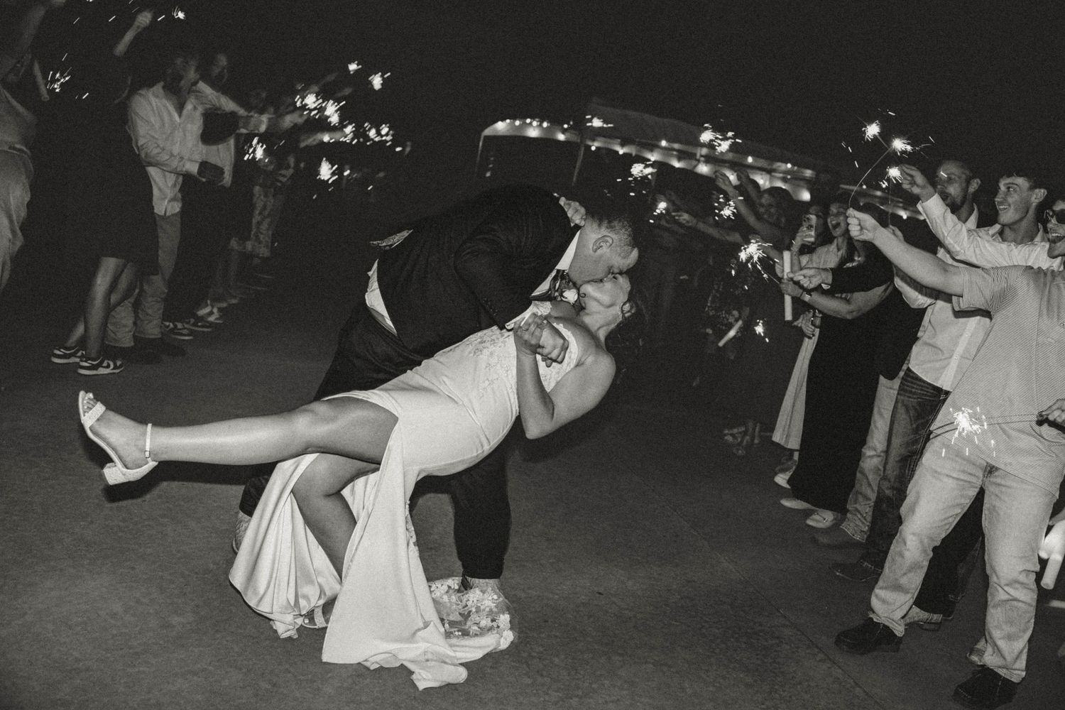 A black and white photograph shows couples dancing at what appears to be a 1950s social gathering or dance hall.