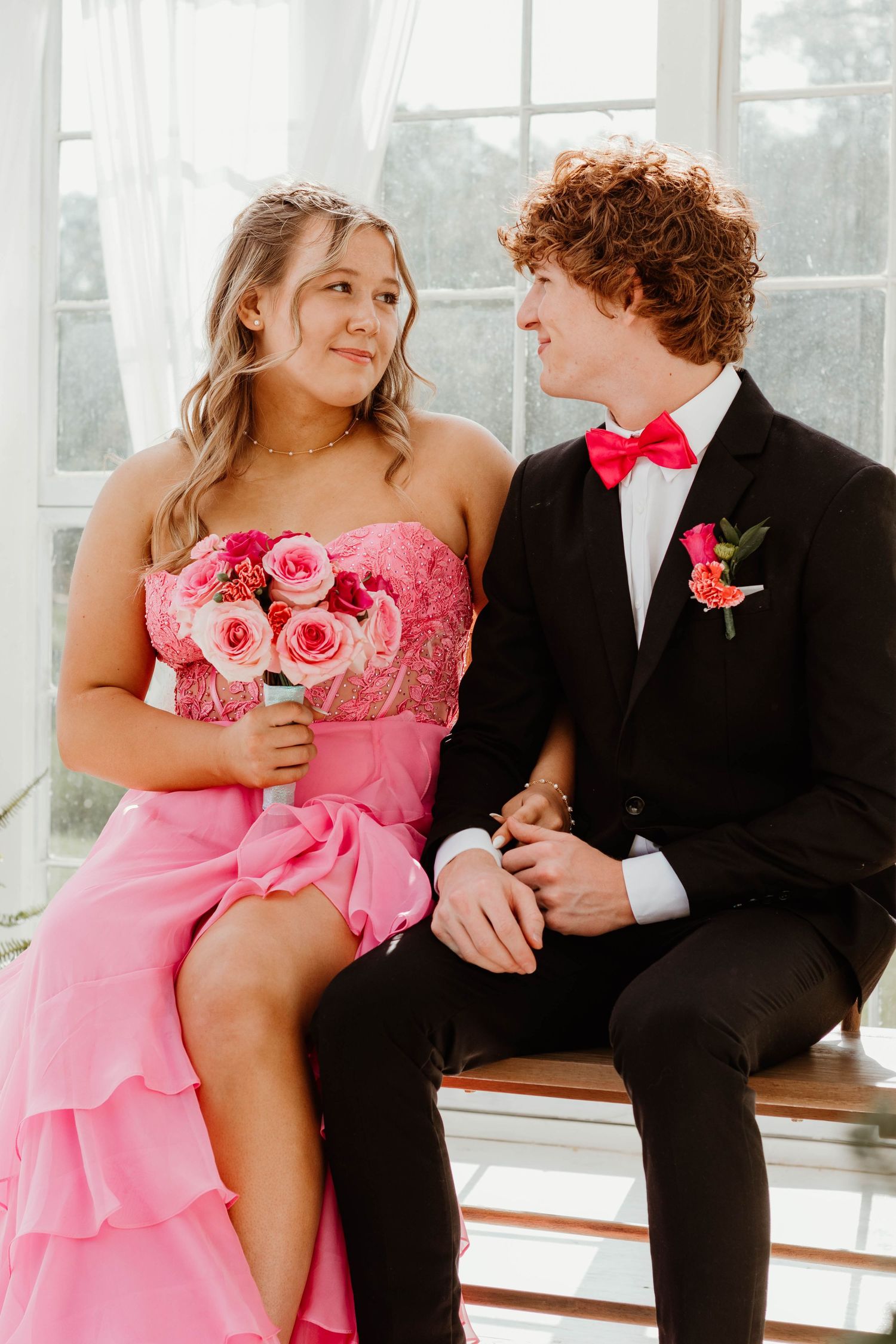 Romantic pink formal attire and black tuxedo couple photoshoot in a greenhouse near Cornelia, Georgia.
