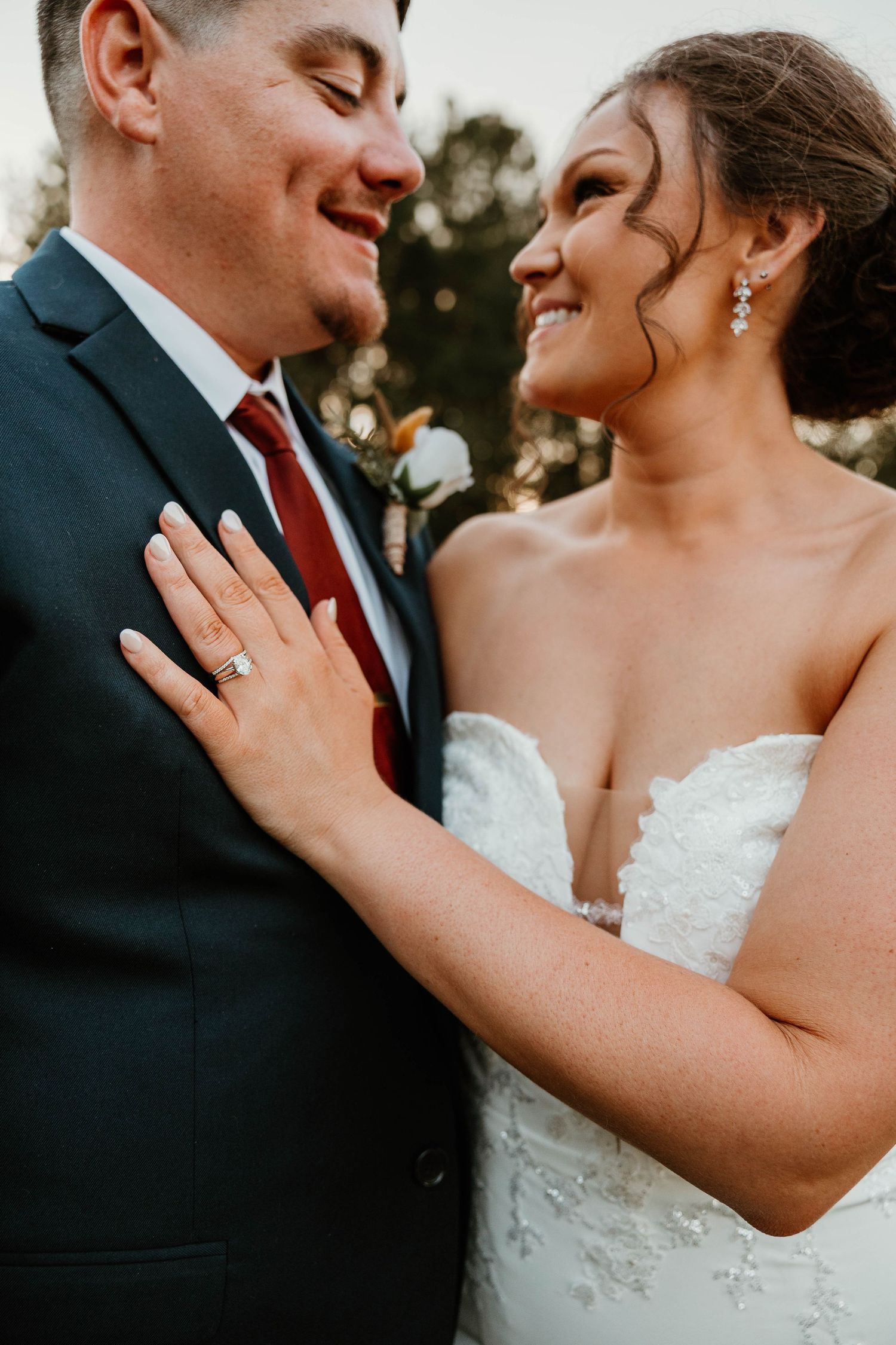 A romantic moment between newlyweds sharing laughter and joy during their outdoor wedding photoshoot.