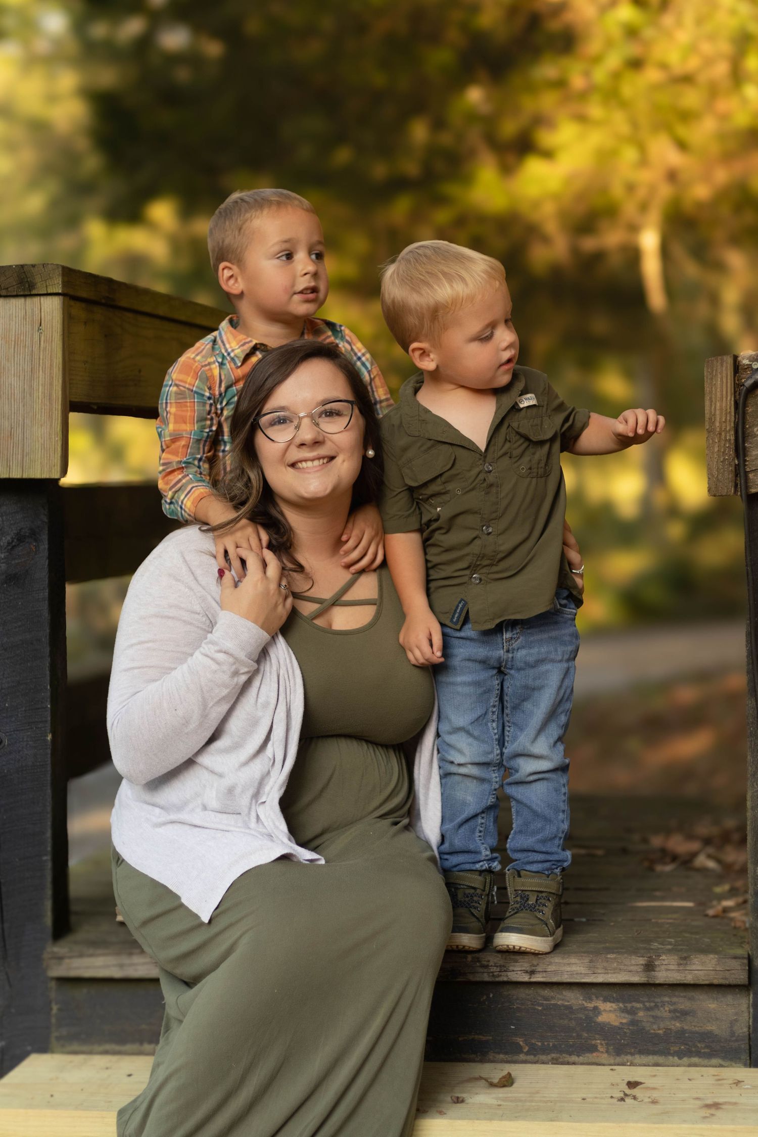 Family sharing tender moments together while seated on a wooden staircase at Geary Farm in Toccoa, GA.