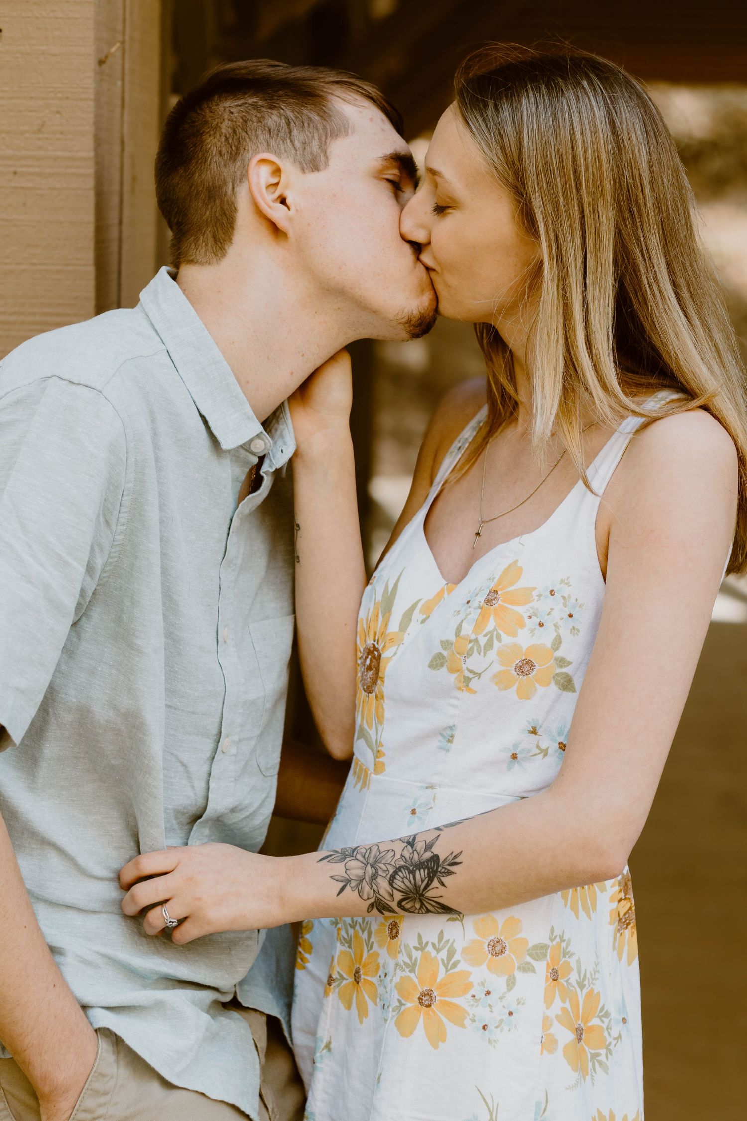 Intimate portraits with yellow floral dress and casual grey shirt in golden lighting in northeast Georgia.