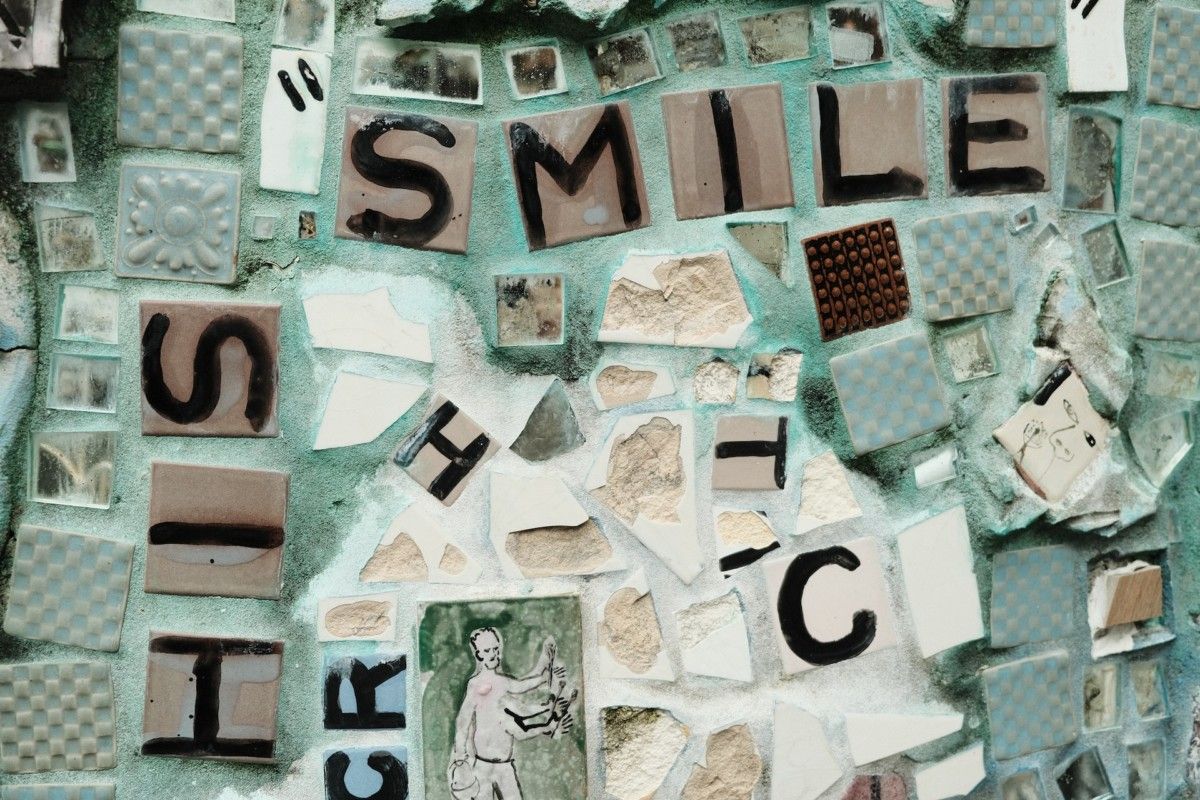 Light green mosaic with tiles spelling smile