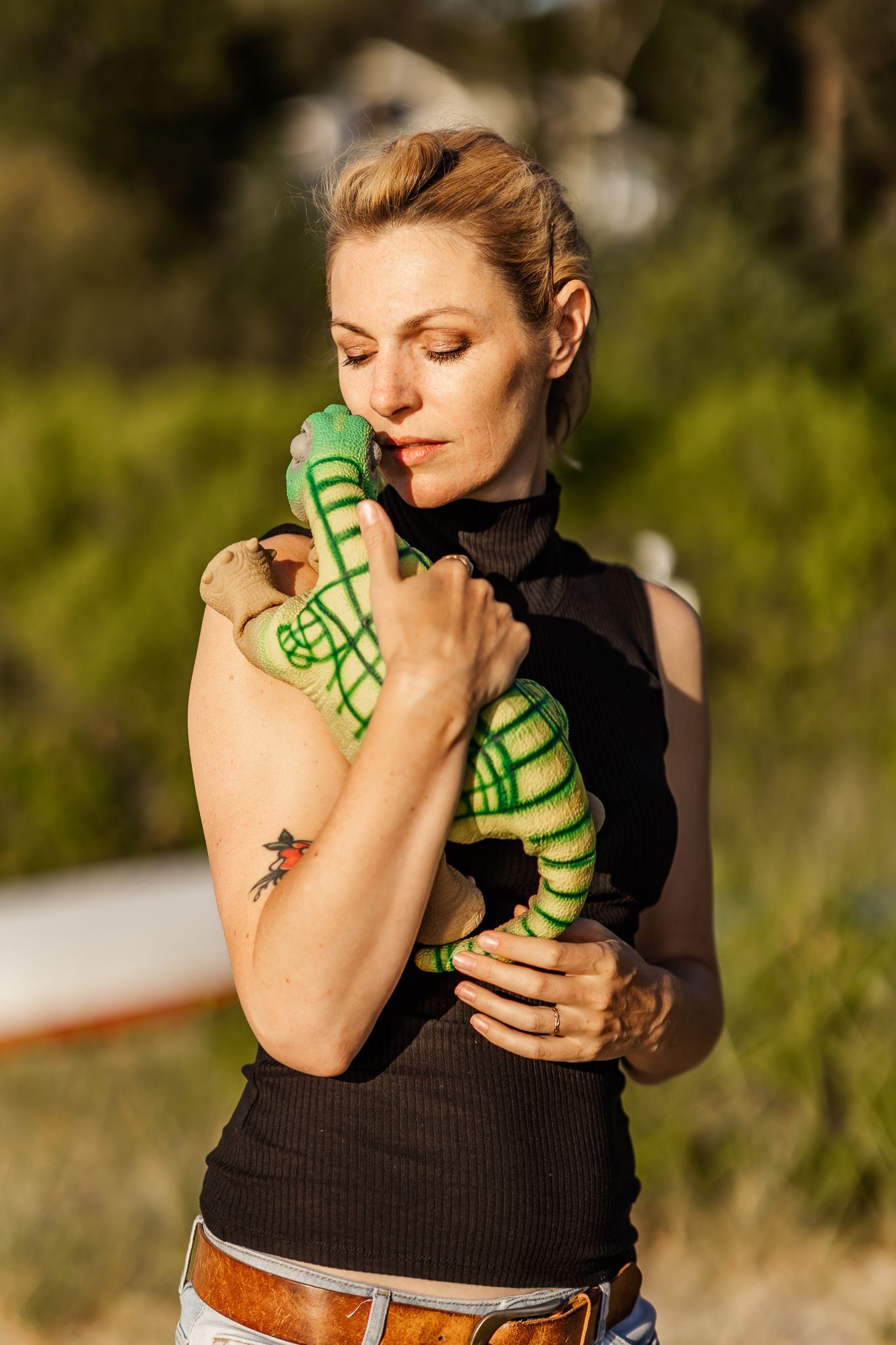 Dr. Kate Darling tenderly holds pleo robot in the golden sunlight