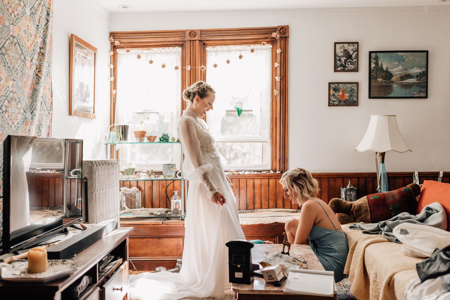 Woman in white dress working at desk in cozy home office with natural lighting and rustic decor.