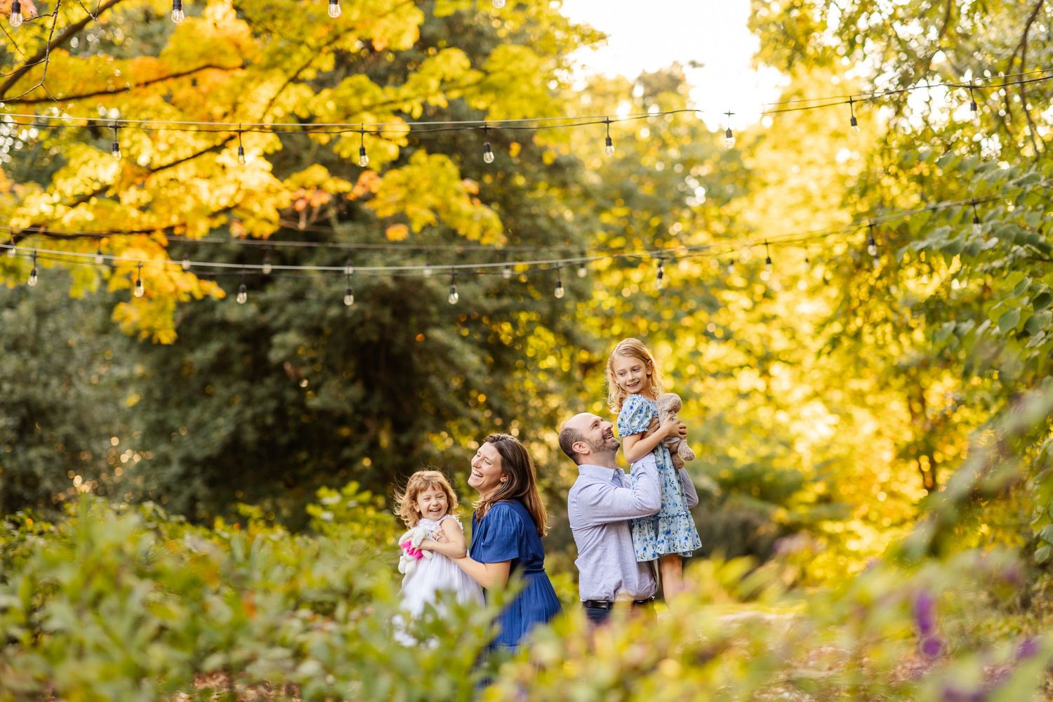 Series of candid family photos with autumn foliage and bright yellow trees in background.