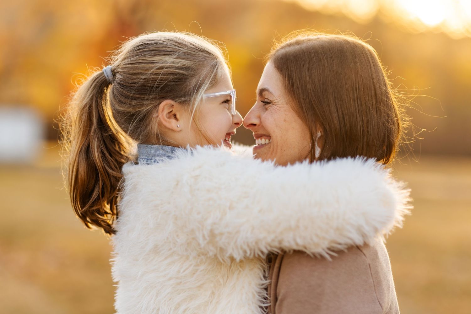 A heartwarming moment between two people captured in golden sunset light.