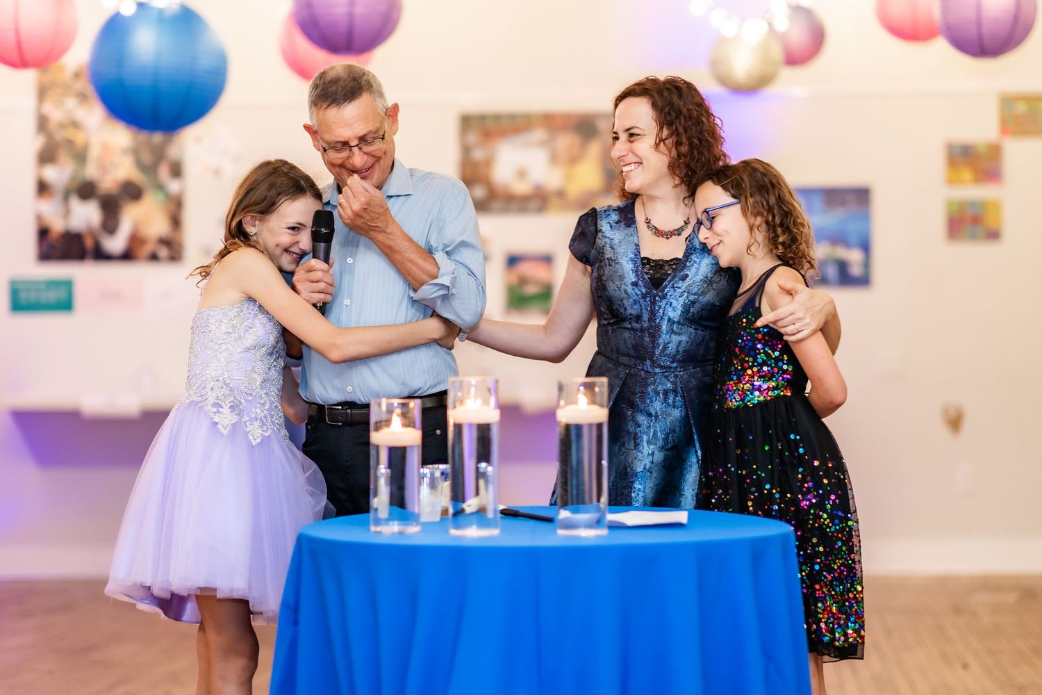 Wedding celebration with blue and purple paper lanterns hanging from the ceiling.