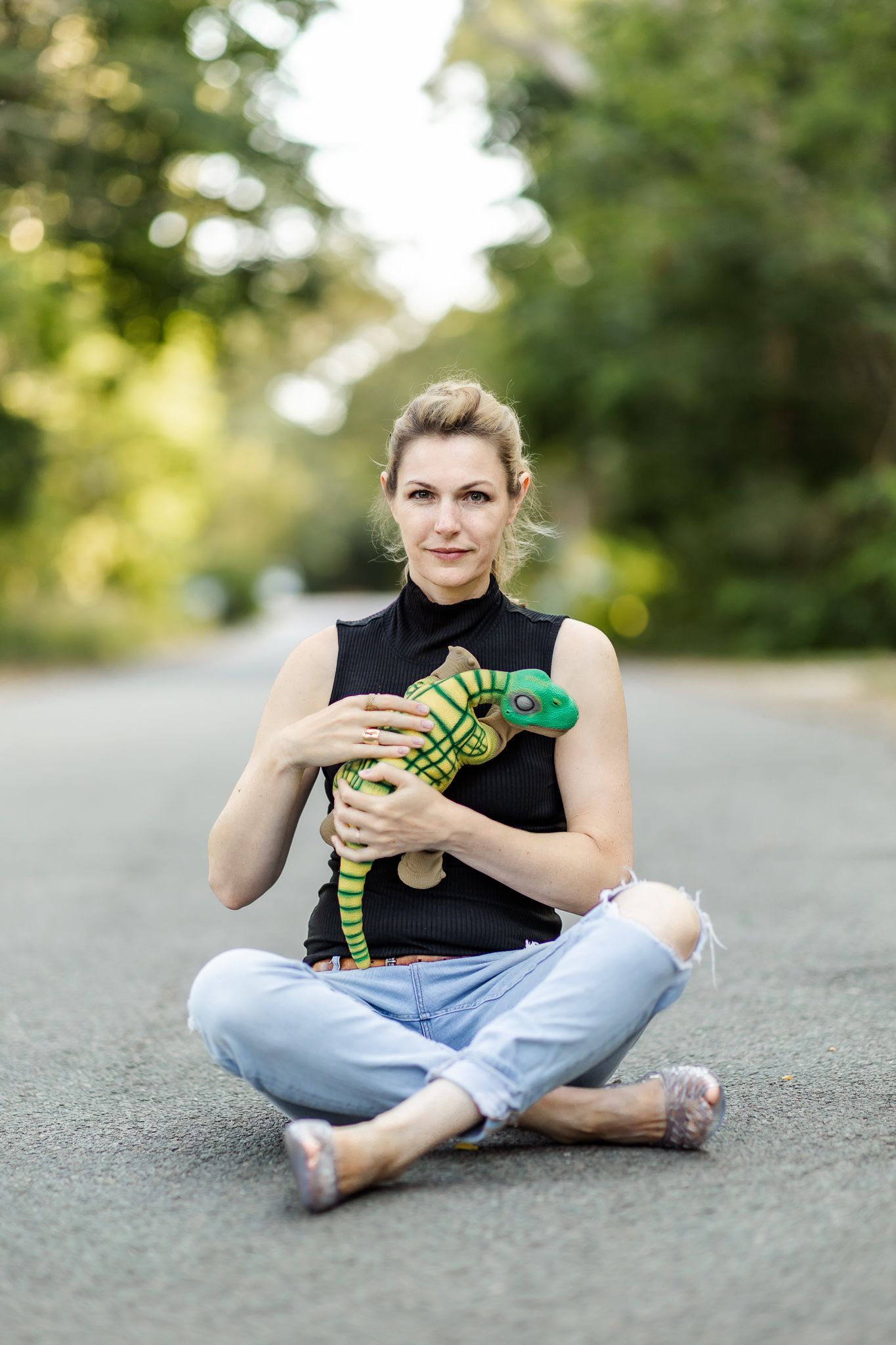 Kate Darling sits in the road with pleo robot