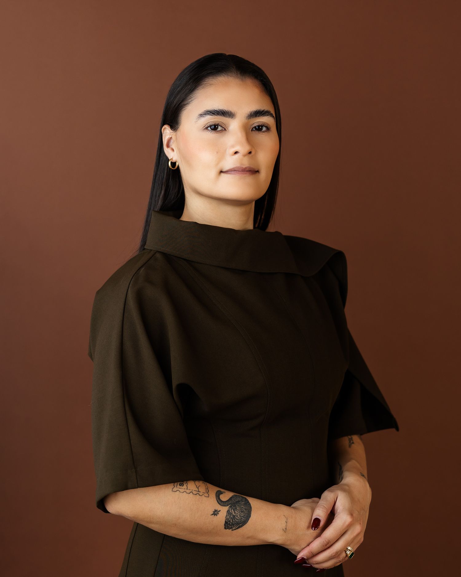 A series of artistic portraits showing a person in a black scarf against a brown backdrop, creating a dramatic visual effect.
