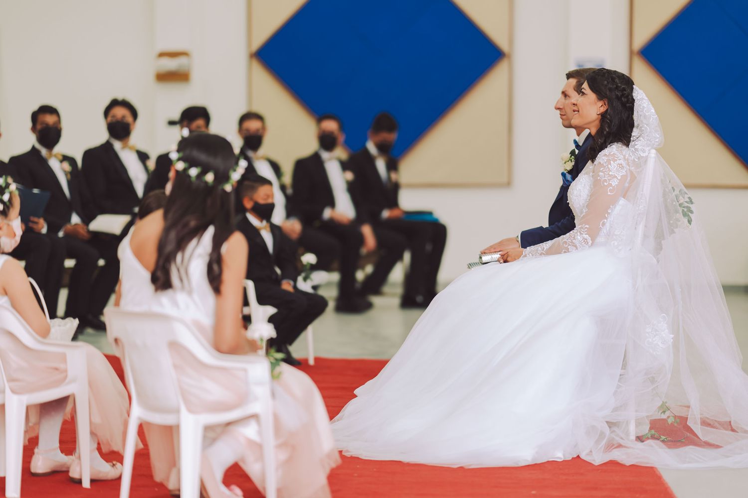 Novios sentados frente a frente durante la ceremonia de su boda.