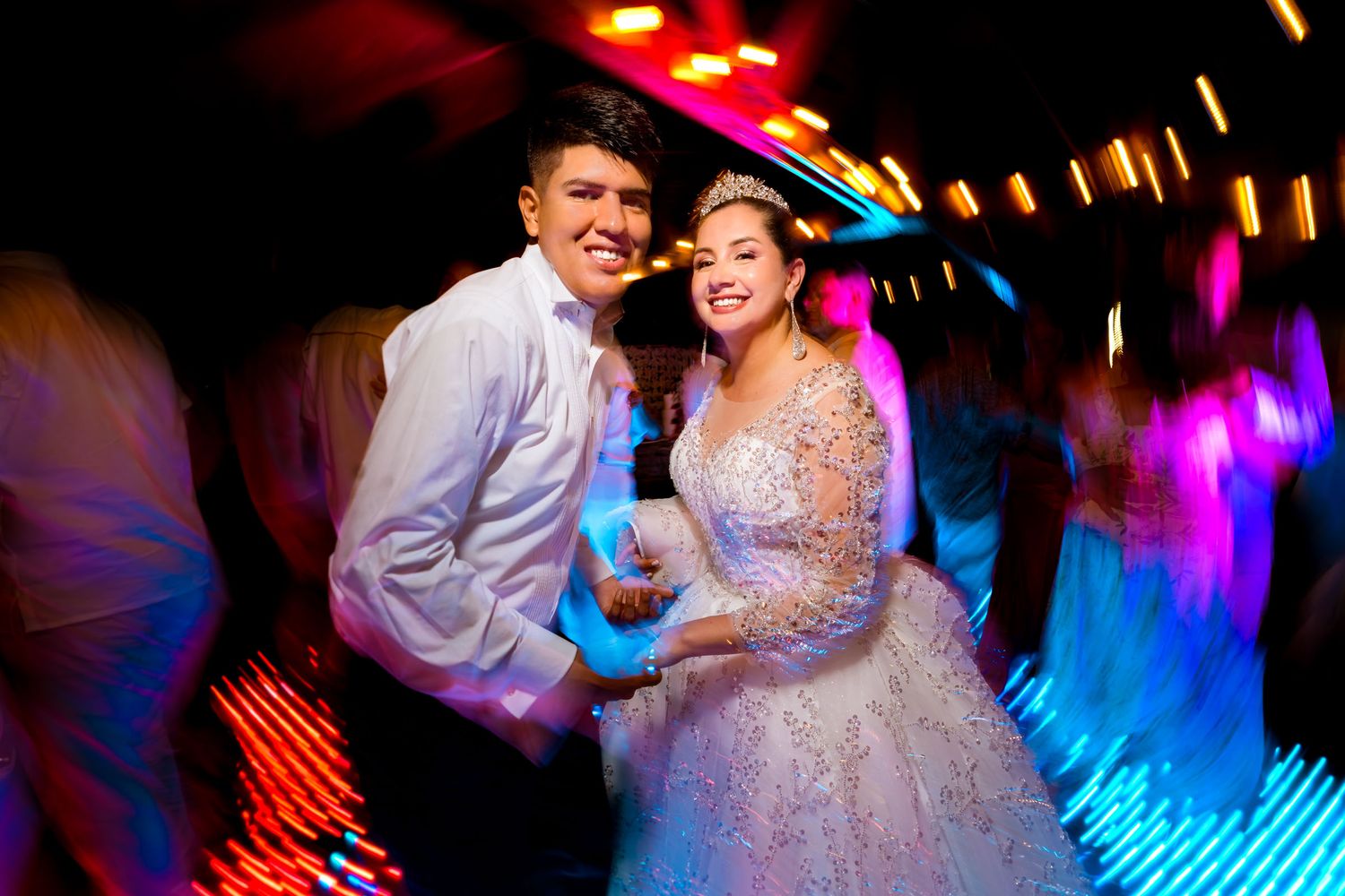 Foto artística de los novios bailando con efecto de luces y movimiento durante la hora loca de la boda