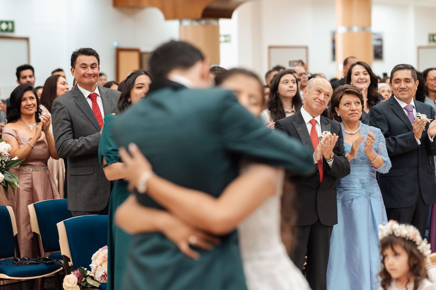 Novio conmovido abrazando a ser querido en momento emotivo de boda.