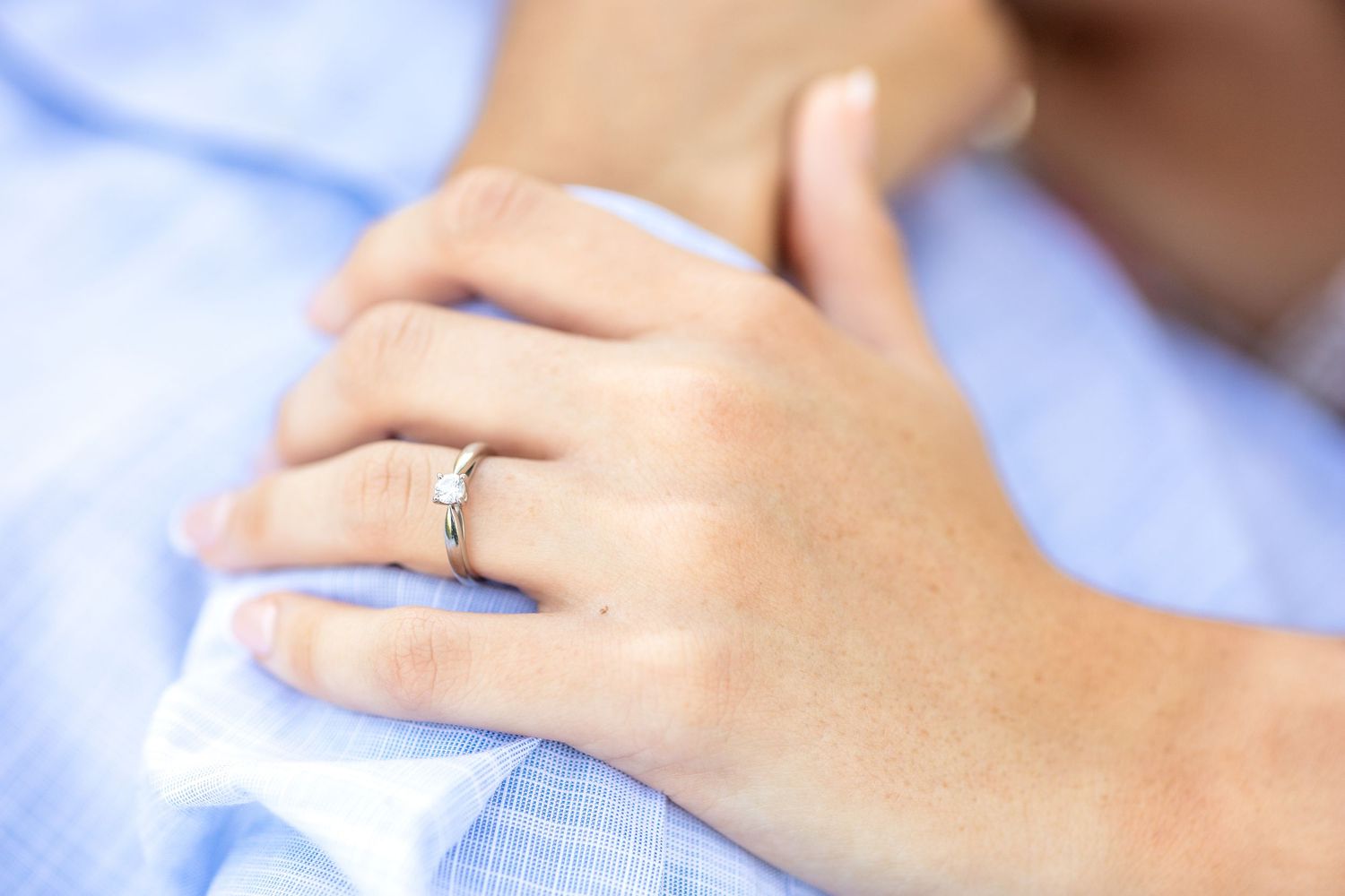 Detail close up image of a bride-to-be's engagement ring at White Rock Lake in Dallas, TX