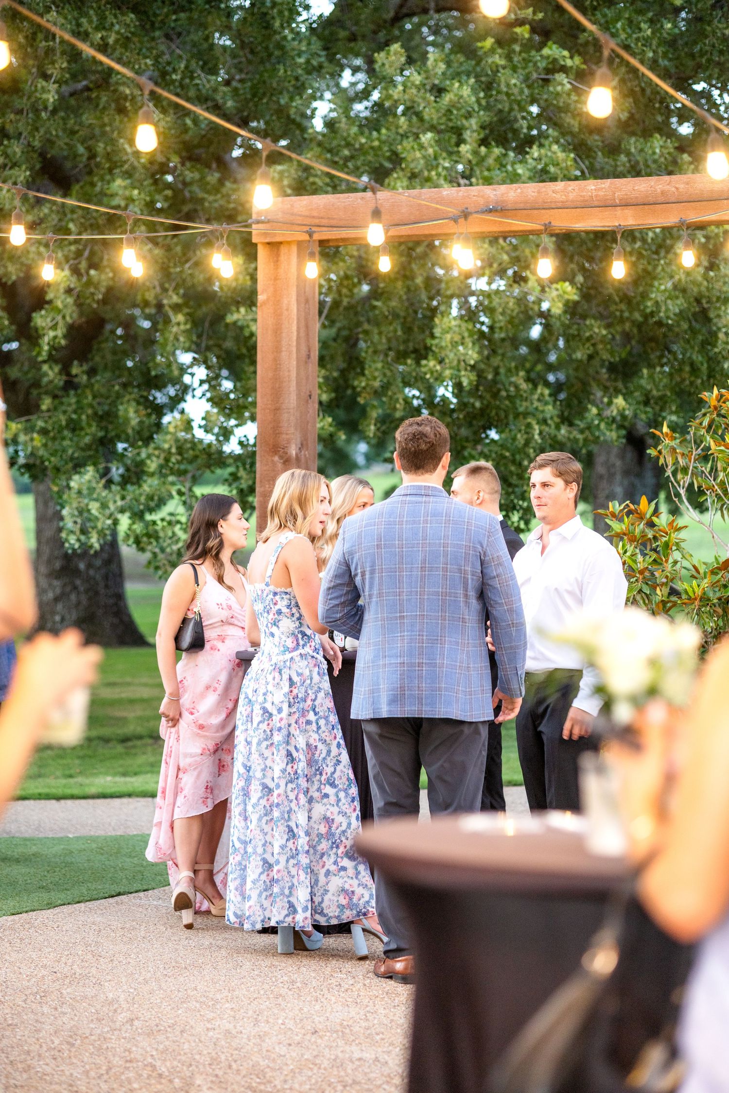 Cocktail hour at Dallas wedding ceremony with guests standing around tables socializing