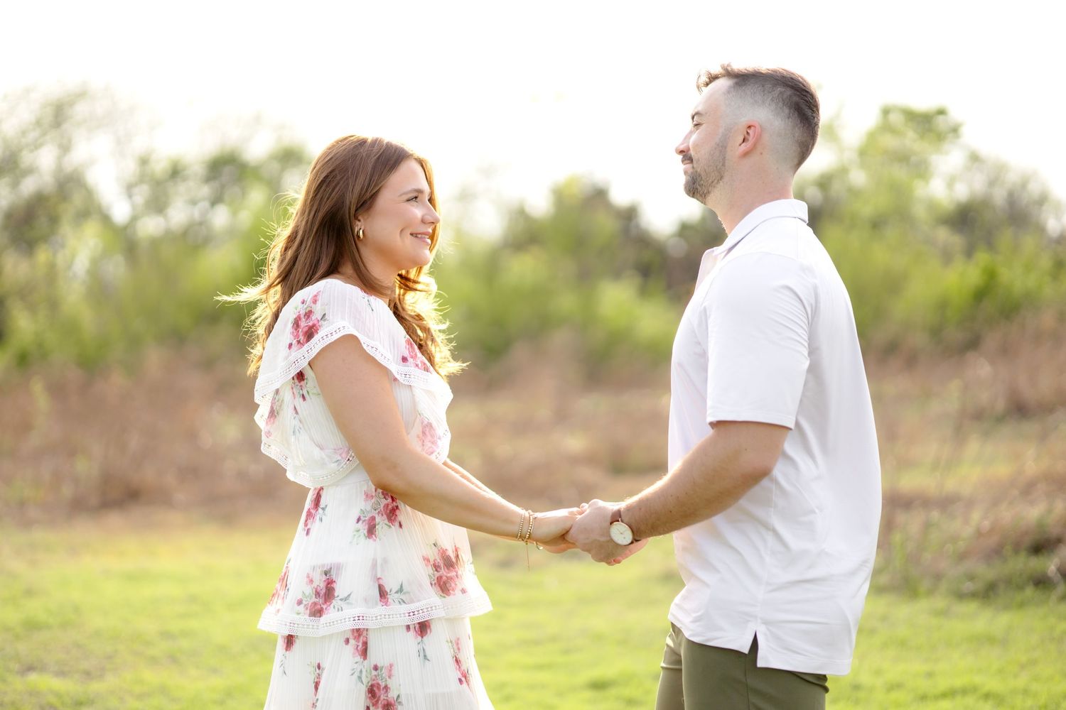 Married couple holding hands and talking during their couples photo session at White Rock Lake