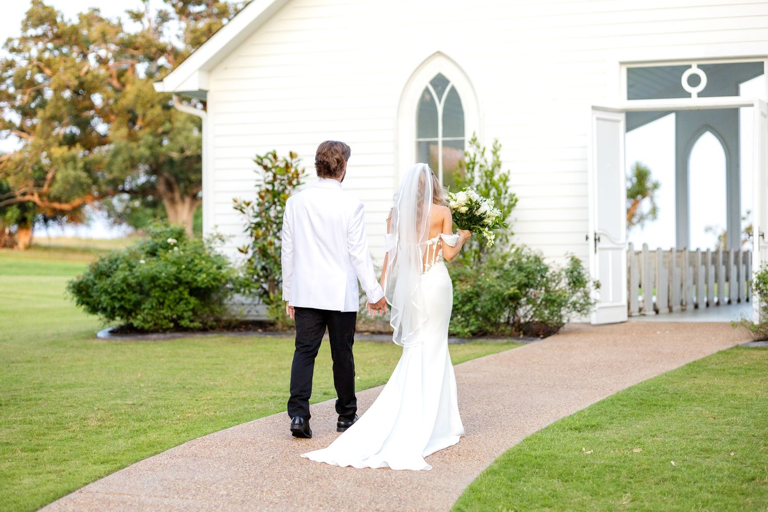 Bride and groom walking into the Dallas wedding chapel at Chandelier Farms